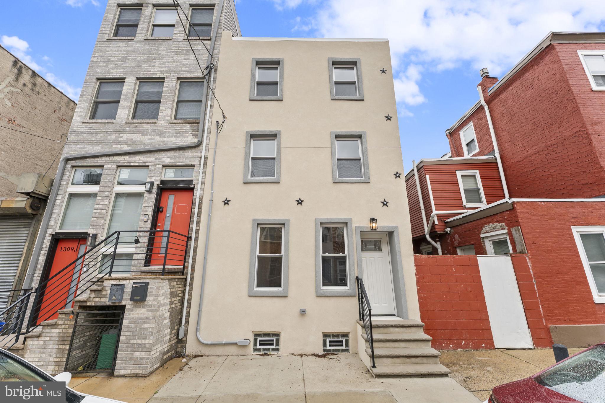 Take advantage of the rare opportunity to own a fully renovated home with the added benefit of a 10-year tax abatement, delivering significant long-term savings. Extensively rebuilt from the framing up, this residence offers the look, feel, and finishes of new construction while maintaining the charm of city living.

Perfectly positioned just outside Olde Kensington and moments from Northern Liberties, Fishtown, and Center City, this three-story home offers approximately three levels of thoughtfully designed living space with 3 bedrooms and 3.5 bathrooms. Each bedroom features its own private full bath, providing exceptional comfort, privacy, and flexibility for homeowners, guests, or roommates.

The main level welcomes you with an open and inviting layout accented by rich hardwood flooring throughout. The spacious living and dining areas flow seamlessly into the beautifully appointed kitchen, where you'll find white shaker cabinetry, stainless steel appliances, a classic subway tile backsplash, and a skylight that fills the space with natural light. A rear addition expands the kitchen and living area, creating an ideal setting for everyday living and entertaining. A conveniently located powder room completes the first floor.

Step outside to enjoy the generously sized, fenced rear yard—a rare outdoor retreat with endless possibilities for entertaining, gardening, relaxing, or creating your own private oasis.

The second floor offers two spacious bedroom suites, while the entire third level is dedicated to an additional private suite, making it an ideal primary retreat or guest accommodations. Every full bathroom has been finished with stylish tilework, glass-enclosed showers, and contemporary vanities, creating a clean, modern aesthetic throughout.

The basement provides dedicated laundry space, mechanical systems, and plenty of room for storage.

Conveniently located near neighborhood parks, restaurants, coffee shops, public transportation, and all that Philadelphia's most vibrant neighborhoods have to offer, this home combines quality craftsmanship, modern finishes, valuable tax savings, and an unbeatable location. Schedule your private tour today and discover everything this exceptional property has to offer.