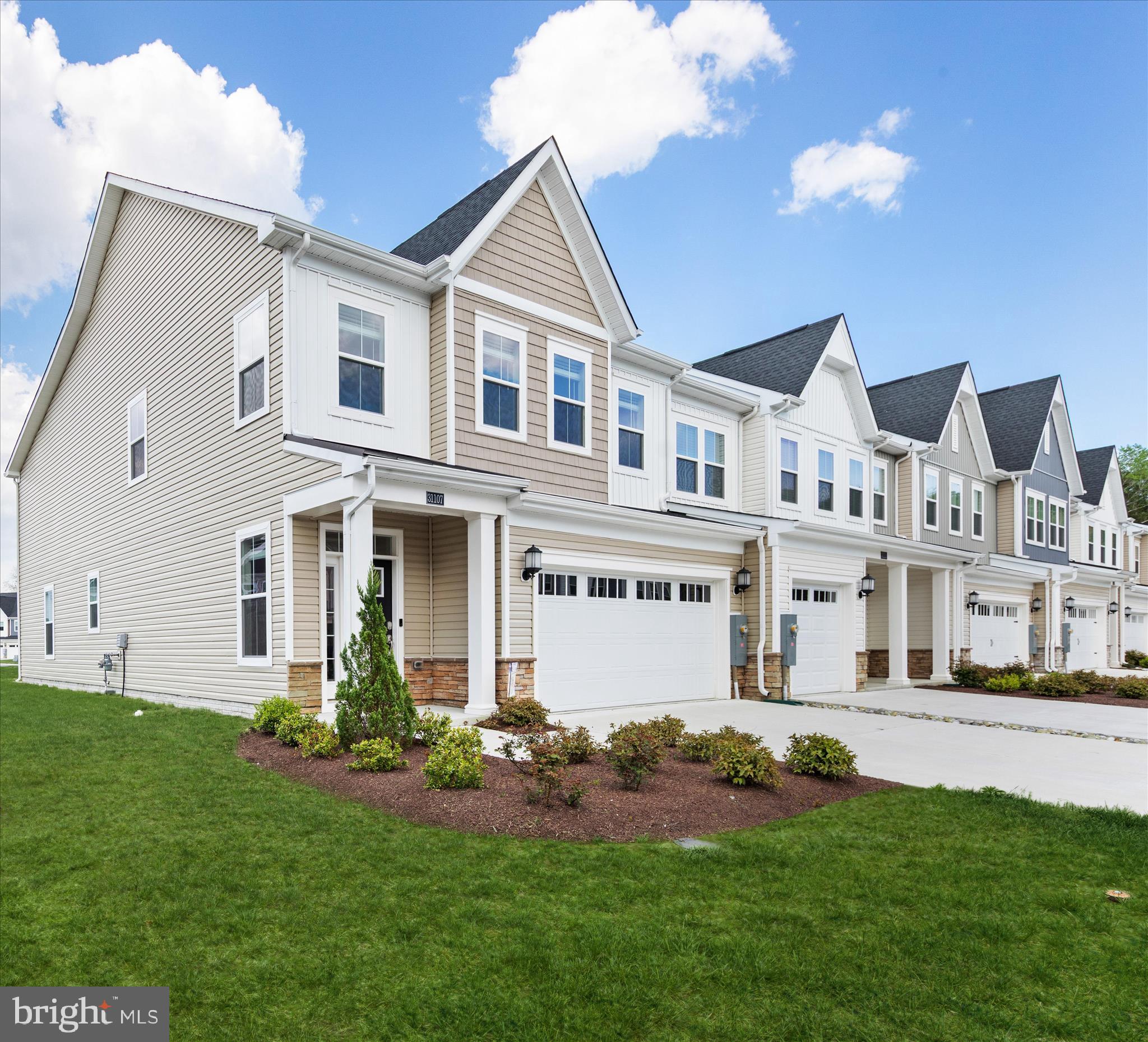 A must see!  Welcome to 31107 Christies Way, a beautifully appointed end-unit townhome in the highly desirable community of Milo’s Haven.  Built in 2024 and set on a premium corner lot, this exceptional residence offers attractive curb appeal with thoughtfully landscaped grounds, a covered entry, and an inviting transom door with a sidelight panel.

From the moment you step inside, you are greeted by a light and airy interior featuring a soft white palette, 9 ft.+ ceilings, crown molding and upgraded, luxury vinyl plank flooring that flows seamlessly through the main living areas.

The open-concept floor plan showcases a gorgeous gourmet kitchen that will impress any home chef. Package upgrades include quartz countertops, crisp white trim-topped cabinetry, soft-close features, and a suite of like-new stainless-steel appliances create a polished and functional space. A five-burner gas cooktop, double wall ovens, classic subway tile backsplash, pull-out drawers, and a spacious island with additional seating make this kitchen the true heart of the home. The adjoining living room features vaulted ceilings and double sliding glass doors that open to a screened porch and paver patio, offering the perfect setting for indoor-outdoor living and entertaining.

This thoughtfully designed home includes four bedrooms, highlighted by two spacious primary suites, including one conveniently located on the main level. The main-level primary retreat features a tray ceiling, walk-in closet, and a beautifully finished ensuite bath complete with tile flooring, dual sink vanity, frameless shower with dual showerheads and bench seating, and a private water closet. The main level also includes a convenient powder room and a laundry room with direct access to the fully finished, drywalled, 2- car garage.

Upstairs, an oversized loft provides a versatile gathering space and serves as the hub for three additional bedrooms, all with walk-in closets and neutral carpeting. A second primary suite with a private ensuite bath, along with two additional bedrooms serviced by a hall bath, ensures ample space for family and guests. 

Milo’s Haven offers a welcoming community atmosphere with low-maintenance living, making it ideal for both full-time residents and those seeking a coastal retreat.  Amenities include a swimming pool and walking trails, all while being conveniently located near beaches, restaurants, shopping and golf.  Whether you are looking for a primary residence, vacation getaway or coastal investment, this nearly new home blends modern design, coastal charm, and an unbeatable location, offering an exceptional opportunity to enjoy the very best of Delaware beach living!