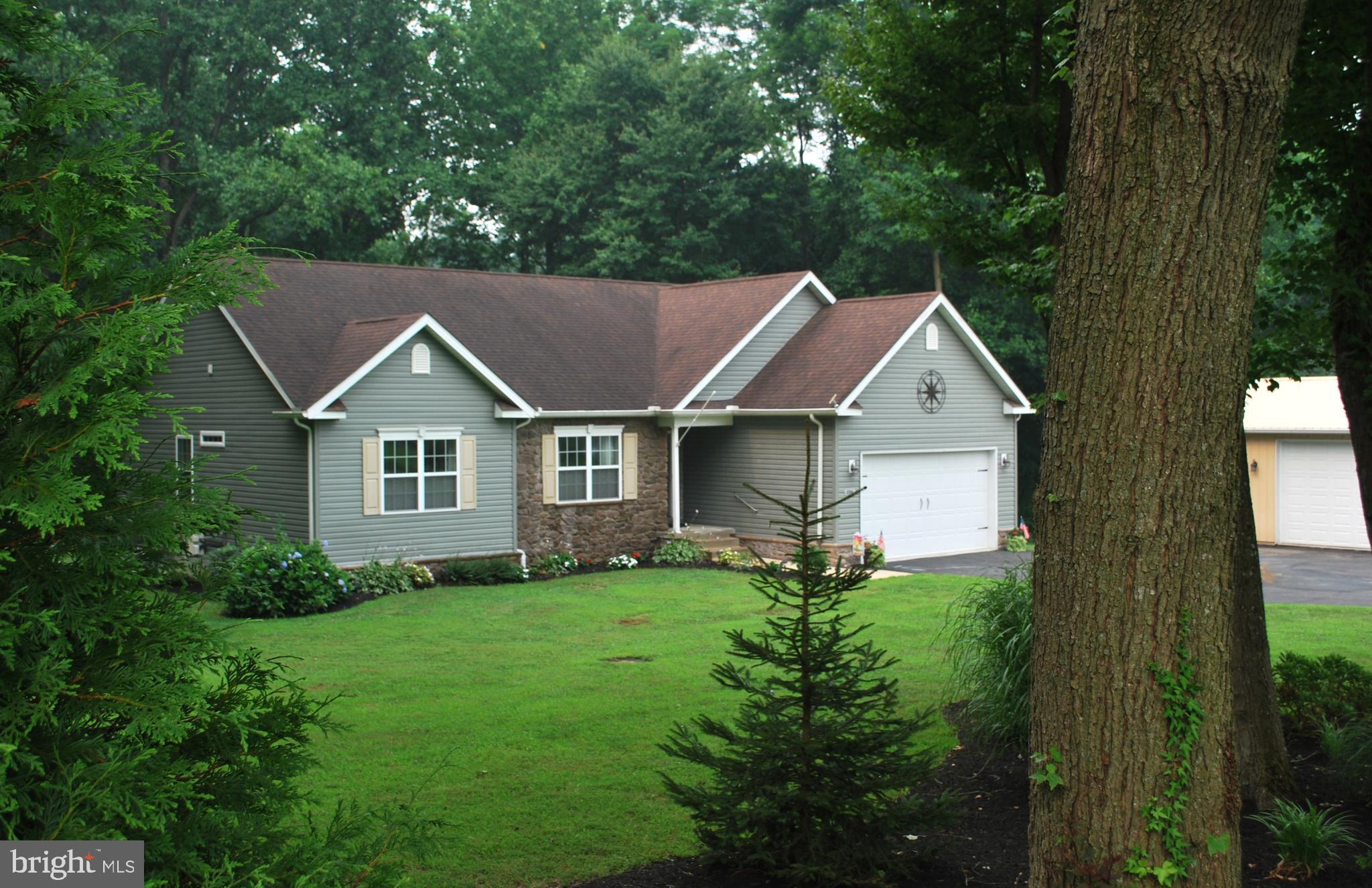 A little piece of Paradise on your own 10.20+- Acres  surrounded by woods & stream for the outdoor enthusiast that enjoys taking walks or want  to hunt on THEIR own land....includes 2 hunting blinds that stays! If you just want to relax, then you will LOVE the beautiful landscaped yard that  has gorgeous flowers, fruit trees & raised garden beds to grow your own veggies and comes with it's own compost containers!  A  24x32x10 POLE BARN with a wood burning stove, cabinets, work bench, 100 amp electric & Dust to Dawn lights & motion detectors all set up  for  the  person which loves to TINKER  or just want to have their own space to do their own thing! Large shed in back yard 10 x 12  for outside storage! 1000 LP  tank...owned by owners...use whomever you wish without being tied to one vendor.  There is just so much, much more to say about this property ...... I haven't even started on the inside.....It's IN BEAUTIFUL CONDITION!!  Another GREAT FEATURE about it.....(what so many people looking  for. these days).. is a IN-LAW-SUITE, with a  SRE-3000 Stairlift , designed  for someone that  may have  difficulty doing stairs but want to have their own space and privacy! All appliances stays up and down! 2-sets washers/dryers; 2 microwaves, 2 refrigerators;  2  stoves, Sprinkler System throughout home with its own water storage tank.
 FEEL FREE TO GIVE ME A CALL IF ANY QUESTIONS!! IT'S A BEAUTY  AND YOU WILL WANT TO CALL THIS ONE HOME!!