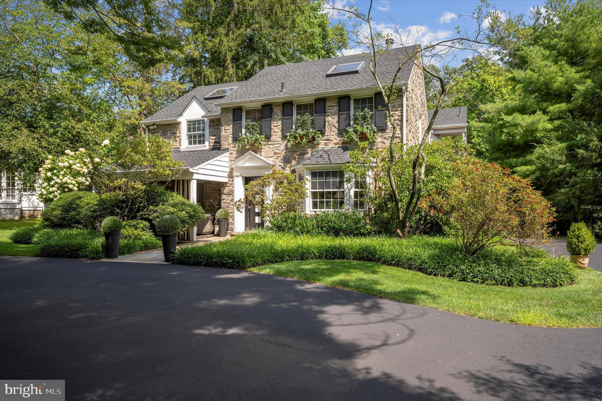 Introducing 909 Centennial Road, a captivating stone colonial home nestled in the highly sought-after neighborhood of Penn Valley within the award-winning Lower Merion Township. This remarkable property exudes timeless elegance and boasts a wealth of luxurious features.

As you approach this home you immediately see the inviting and charming Front Porch.  You enter the home through the striking black and white architectural front door and you are greeted by the grandeur of rounded archways leading into a spacious dining room adorned with inlaid hardwood floors. The adjacent kitchen beckons with a breakfast room and a large island featuring a counter bar and creating the perfect setting for culinary delights and casual gatherings.
Co-listing agent is related to Seller


A few steps down you'll find a cozy family room adorned with a black marble fireplace and built-in floating shelves, all complemented by the allure of new Pella windows. The adjacent bar area, complete with a brass sink and mirrored shelves, offers a touch of sophistication while providing a seamless transition to the breathtaking view of the pool and expansive backyard.

The first floor also presents a powder room, a large coat closet, an office/den with elevator access, and a living room boasting a stone fireplace, brass and wood mantle, and large bay windows that bathe the space in natural light.

Ascending the open stairway with double brass railings to the second floor, you'll discover a thoughtfully designed layout that includes a series of beautifully appointed four bedrooms. The two very large bedroom both adorned with a skylight features a generously sized walk-in Jack and Jill closet, providing ample storage space and organizational convenience to meet your needs. The hall tiled bathroom, complete with a tub/shower and a window that infuses the space with natural light.The third bedroom, boasting a large closet and an elevator entrance, offers both comfort and practicality, making it a versatile space that can adapt to your specific needs. Conveniently located in the hallway is a laundry room and linen closet, featuring double bifold doors for easy access and discreet storage solutions, ensuring that daily chores are seamlessly integrated into your lifestyle. The master suite is a true sanctuary, featuring a platform bed, built-in nightstands and headboard, and an abundance of Pella windows offering panoramic views of the lush surroundings. The master bath is a luxurious retreat, adorned with marble detailing, a spacious jacuzzi with marble surround, a rejuvenating steam shower with a window and marble bench, and a super wide vanity with double sinks.

The lower level offers additional space for relaxation and entertainment, with a newly carpeted stairway leading to a versatile area that includes a cedar closet, an exercise room with an elevator entrance, a bedroom/playroom with a closet, a sauna, a full tile bath with a stall shower, and ample storage space.

The backyard is truly a haven for outdoor enjoyment and relaxation.The centerpiece of this outdoor oasis is the multi-level decks with an inviting pool, complete with a hot tub, offering the perfect setting for leisurely dips and unwinding.  Amidst the expansive grounds, you'll find ample space for recreation and fun, including a trampoline that promises hours of enjoyment for both children and the young at heart.  The backyard offers endless opportunities to create cherished memories with family and friends.

This exceptional property also features an elevator installed just a few years ago which goes from the basement to the second floor, adding convenience and accessibility to its list of impressive attributes. There is also a generator.

With its enchanting blend of sophisticated charm and modern amenities, 909 Centennial Road is a rare gem in an amazing neighborhood with eazy access to Center City or KOP. Open House Thursday Feb 22nd 4-6pm.