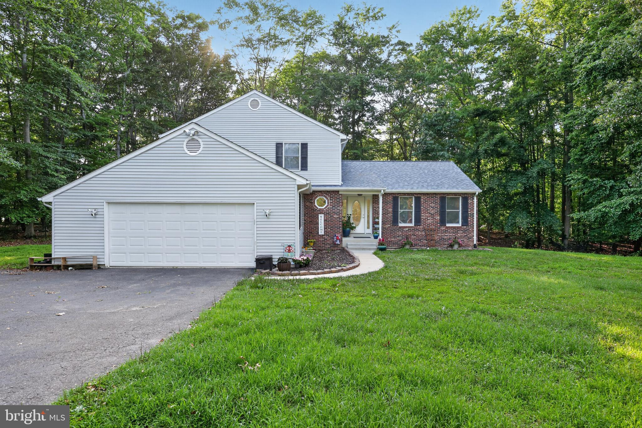 Step into a slice of heaven when you pull up to this spacious home located on two private acres in Bel Alton. Enjoy quiet country living close to shopping  and dining in Southern Maryland. When you walk into the stately foyer of this home, you'll find a formal living room on the right (currently a play room) that leads to a full dining room. The kitchen features stainless steel appliances, granite countertops  and a skylight.  The living room has a gas fireplace and  large open floorpan perfect for entertaining. There is a huge first floor bedroom and half bath on your way to the oversized garage. Extra freezer and fridge in garage convey.  Upstairs you will find three large bedrooms , one hall bath and a large ensuite in the primary bath.  Commuting a breeze to anywhere in the DMV from Chapel Point Woods.  Bel Alton is convenient to local bases such as Indian Head, Joint Andrews Air Force Base, Patuxent River Naval Air Station and Dahlgren.