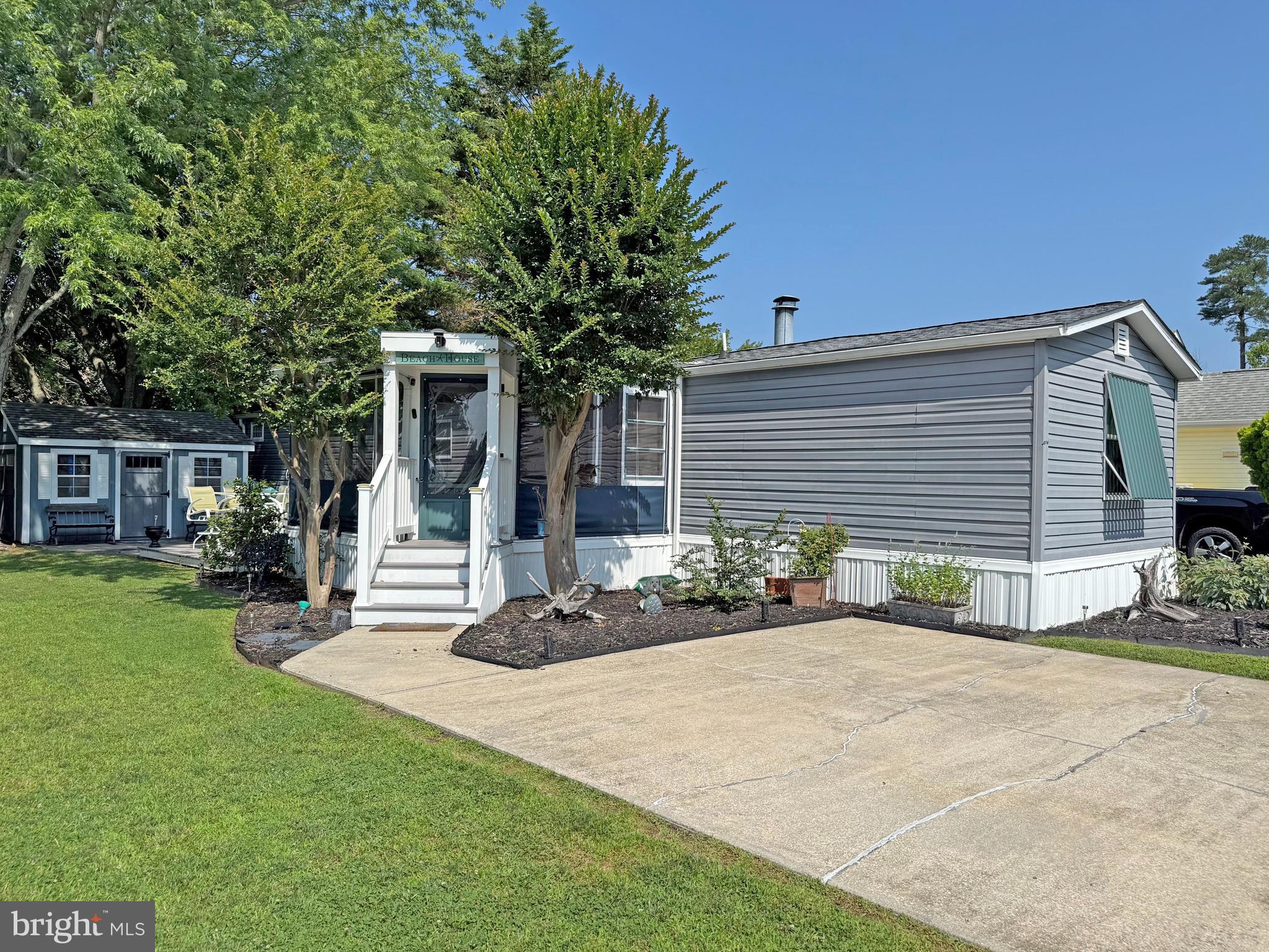 IMMEDIATE OCCUPANCY !Motivated ! This home was nicely remodeled in 2019 & it is just 6.5 miles to the famous Rehoboth boardwalk…but why leave the community when the amenities include a bayfront pool, tennis courts, playgrounds, a sandy beach, crabbing pier, boat slips (for rent), a community boat ramp & more. The home’s living room features an electric fireplace & vaulted ceilings to make that room feel extra spacious. Newer flooring & fixtures throughout. The eat-in kitchen adjoins the living room. It has space for a dinette set & there is a breakfast bar for casual dining. The kitchen has granite countertops, a tile backsplash & stainless steel appliances. There is a fridge with ice maker, smooth-top electric range, built-in microwave, dishwasher & a disposal. The main bedroom is to the rear of the home. It has an elegant en Suite bath, which includes a contemporary double-sink vanity, lighted mirror, a large tiled shower with a multi-spray shower head, towel warmer rack & a cedar-lined linen closet. The main bedroom uses the double closet in the hall and the walk-in closet in the bedroom for clothes. The walk-in closet also houses the stack washer & dryer. The second bedroom is at the front of the home. The second full bath is near bedroom #2, so that bedroom feels like a suite, too. That bath has a step-in shower and an antique dry sink that’s been converted to a sink vanity. Great outdoor living spaces include a big screened porch (with custom vinyl panels), a boardwalk-style deck, and a small paver patio area in front the shed & Double Kayak included. The shed has electric, so you can charge your golf cart! The community allows 2 pets (no fences, though). Leasehold Interest: Lot Rent of approx. $744.29/mt. includes water service & trash/recycle. This Lease renews annually on January 1.  Homeowner pays electric, sewer, cable/Internet, lawn maintenance & there’s a nominal fee for pool passes. Hometown America, the community owner, requires an Application from the Buyer (and all adult occupants 18-year-of-age or older), with acceptance based on the following criteria: 1.)income verification, 2.)credit bureau score, plus evaluation of debt-to-income ratio, and 3.)criminal background check. No short-term rentals, but rental of 6 months or longer may be allowed with Park Management approval. Financing may be available to qualified borrowers from only a few Lenders that specialize in installment/chattel loans for manufactured homes on leased land. Closing costs will include 3.75% DMV Doc Fee & Settlement Agent fee.