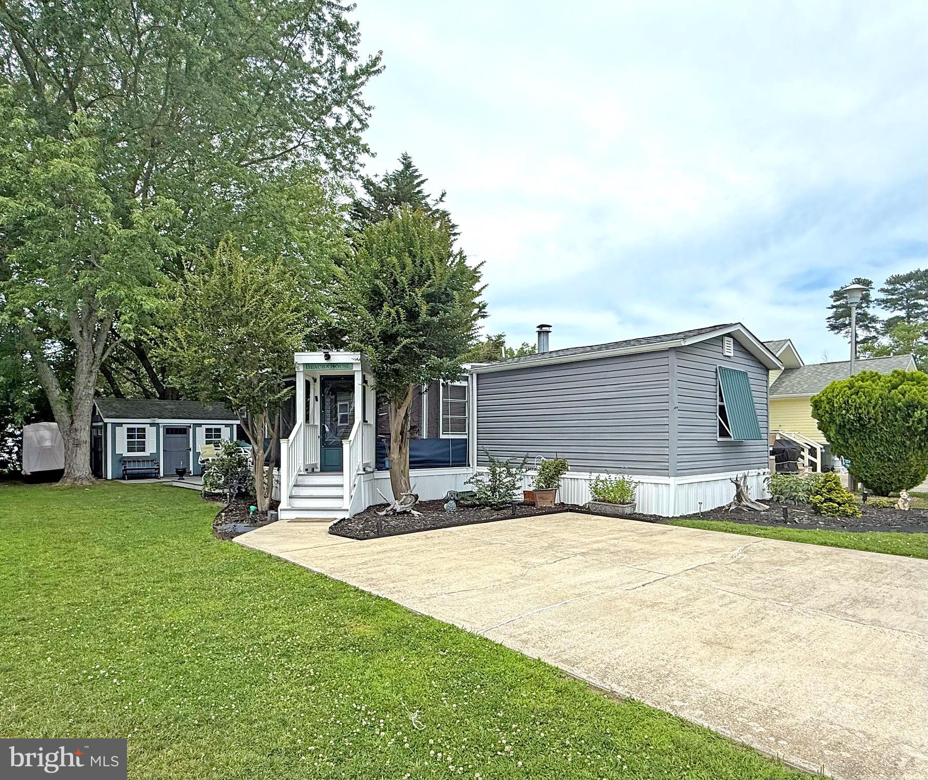 IMMEDIATE OCCUPANCY !Motivated ! This home was nicely remodeled in 2019 & it is just 6.5 miles to the famous Rehoboth boardwalk…but why leave the community when the amenities include a bayfront pool, tennis courts, playgrounds, a sandy beach, crabbing pier, boat slips (for rent), a community boat ramp & more. The home’s living room features an electric fireplace & vaulted ceilings to make that room feel extra spacious. Newer flooring & fixtures throughout. The eat-in kitchen adjoins the living room. It has space for a dinette set & there is a breakfast bar for casual dining. The kitchen has granite countertops, a tile backsplash & stainless steel appliances. There is a fridge with ice maker, smooth-top electric range, built-in microwave, dishwasher & a disposal. The main bedroom is to the rear of the home. It has an elegant en Suite bath, which includes a contemporary double-sink vanity, lighted mirror, a large tiled shower with a multi-spray shower head, towel warmer rack & a cedar-lined linen closet. The main bedroom uses the double closet in the hall and the walk-in closet in the bedroom for clothes. The walk-in closet also houses the stack washer & dryer. The second bedroom is at the front of the home. The second full bath is near bedroom #2, so that bedroom feels like a suite, too. That bath has a step-in shower and an antique dry sink that’s been converted to a sink vanity. Great outdoor living spaces include a big screened porch (with custom vinyl panels), a boardwalk-style deck, and a small paver patio area in front the shed & Double Kayak included. The shed has electric, so you can charge your golf cart! The community allows 2 pets (no fences, though). Leasehold Interest: Lot Rent of approx. $744.29/mt. includes water service & trash/recycle. This Lease renews annually on January 1.  Homeowner pays electric, sewer, cable/Internet, lawn maintenance & there’s a nominal fee for pool passes. Hometown America, the community owner, requires an Application from the Buyer (and all adult occupants 18-year-of-age or older), with acceptance based on the following criteria: 1.)income verification, 2.)credit bureau score, plus evaluation of debt-to-income ratio, and 3.)criminal background check. No short-term rentals, but rental of 6 months or longer may be allowed with Park Management approval. Financing may be available to qualified borrowers from only a few Lenders that specialize in installment/chattel loans for manufactured homes on leased land. Closing costs will include 3.75% DMV Doc Fee & Settlement Agent fee.
