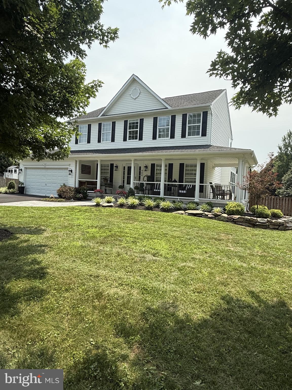 Meticulously maintained luxury home shows like a professionally designed model! Situated on a fully fenced corner lot with the most extraordinary landscaping in the community, this 5BR/3.5BA masterpiece has it all. Enjoy outdoor living on the covered wrap-around front porch or the relaxing screened-in side porch. The main level boasts a stunning, fully renovated kitchen with high-end custom cabinetry and a huge quartz island that flows into the family room. Escape to the primary suite featuring a custom walk-in closet and a totally renovated spa-like bath with a soaking tub and state-of-the-art shower. The finished lower level offers a massive rec room/theater space, bedroom, and full bath. Features a main-level laundry and an oversized 2-car garage with workbenches. See the docs section for a full list of extensive updates! Full video, photos and tour reel coming.