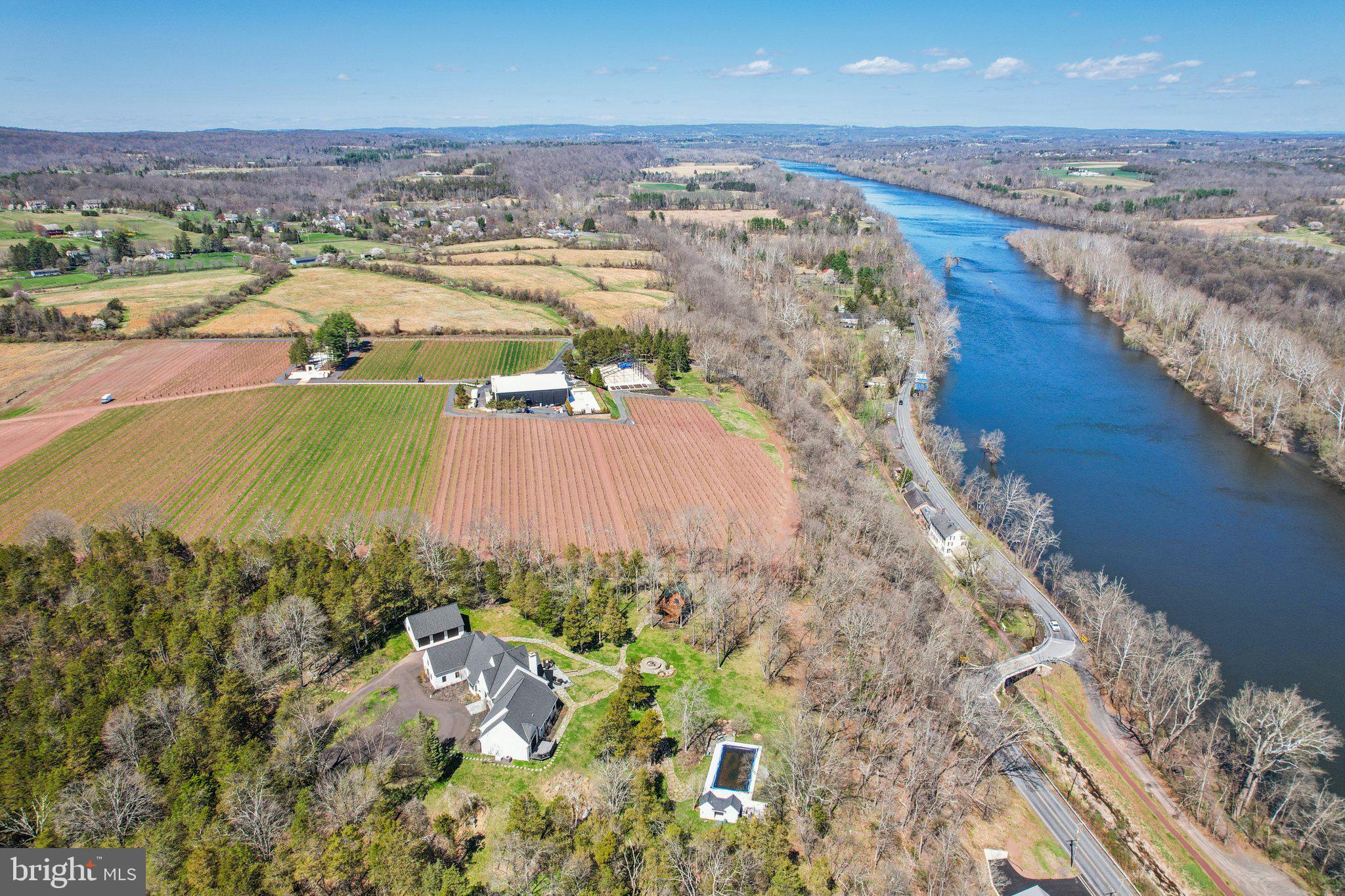 Set at the end of a private lane, the long meandering driveway  flanked by mature trees in a rustic landscape is "Cedar Hill Reserve".  This one of a kind custom built home has panoramic views above the Delaware river and sweeping uninterrupted sightlines for miles across the rich rolling landscapes of Bucks and Hunterdon counties.   Enter through the front door and your eyes are immediately drawn the two story bank of French doors & windows framing the bucolic setting. The large open floor plan combines comfortable living space with a sophisticated chef style kitchen, large island, plumbed antique worktop coffee station and two tier stone stacked wood burning fireplace.  The formal dining room, with custom millwork is just steps from the kitchen and offers plenty of room for guests and a bank of windows overlooking the lush tree line. The main floor continues with an expansive home office surrounded by built in book shelves and work station with views of the river.  The master suite is an oasis with multiple custom finished walk-in closets, sumptuous master bath, vaulted ceiling and French doors that open to a private deck for morning coffee or evenings counting the stars. There are two more generous en-suites on the main floor and a great view from any window. The two story wing of this estate style home provides a full suite for guests with ample room for storage and possible additional finished space.  There is a three car attached and a brand new three car detached garage  with electric and water plumbed in. The sunny backyard is a recreational retreat with an in-ground pool & pool house overlooking the river valley and heated tree house with wrap around deck with views across the neighboring vineyard and miles across the river. The timeless mature landscape completely surrounds the sleek & sophisticated country home. Just a short drive to New Hope, Frenchtown, Easton and well within commuting distance to NYC.  Schedule your private tour today!
“The river has great wisdom and whispers its secrets to the hearts of men.” 
- Mark Twain