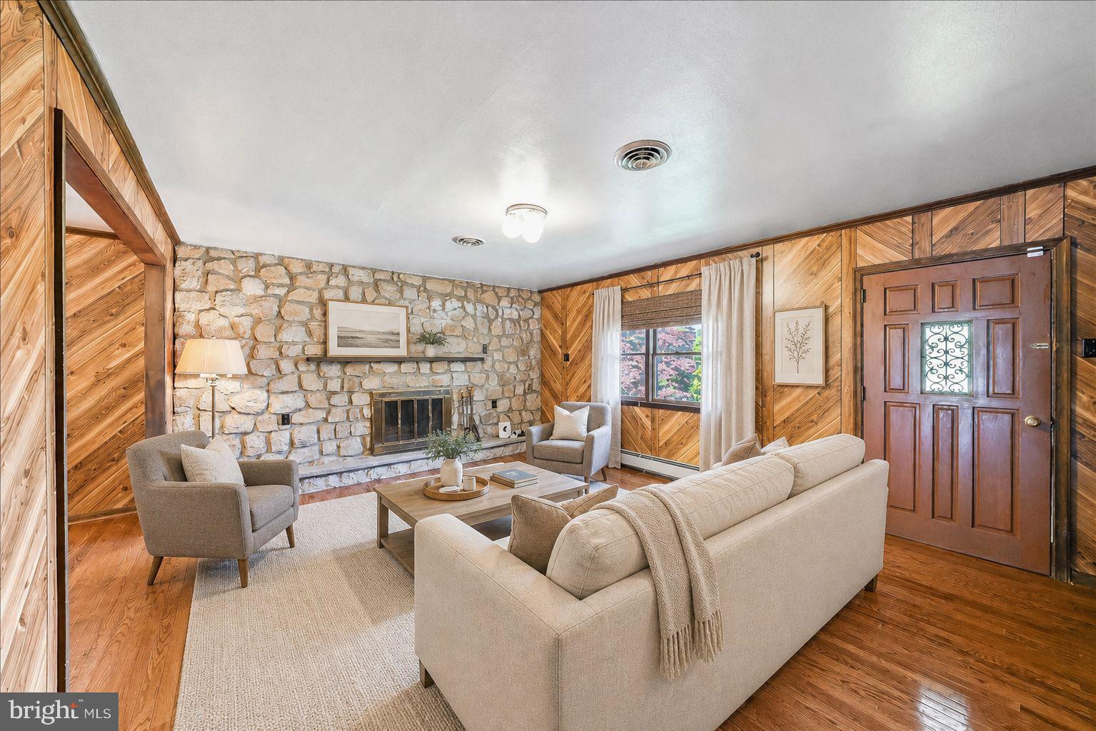 In-law suite possibility at this lovely stone home. Raised ranch featuring 3 bedrooms on the main level of the home with a full bath plus a large living room with a stone fireplace, formal dining room and eat-in kitchen. Just off the eat-in kitchen is a bright & cheery sunroom which leads to the rear and side yards. The lower level with a walk-out to the driveway and garage area also has another stone fireplace in the spacious family room with a second eat-in kitchen area, full bath, additional bedroom or office as well as a laundry/utility room. In-law suite potential on the lower walk-out level to driveway. The oversized one car garage has ample shelving for storage as well as a large separate workshop under the sunroom for additional storage. Parking for 4 cars is available on the driveway. Central air. Unique floor plan if you may have a need for an in-law suite within your home. Great location!