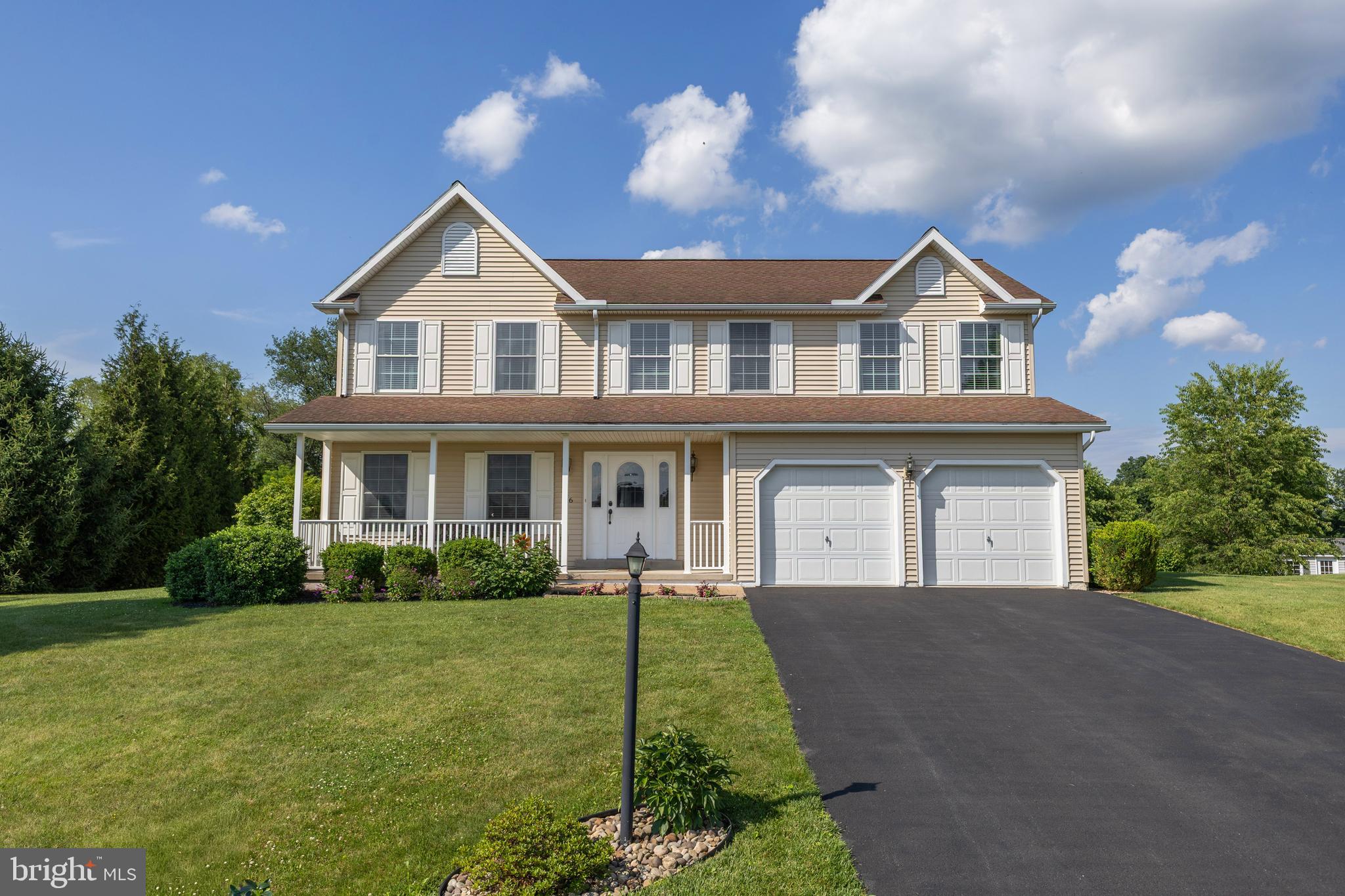 Welcome to this beautifully maintained two-story home, perfectly situated on a spacious lot in the desirable Springfield neighborhood backing to beautiful views of the mountains and farmlands. Designed for both comfort and entertaining, the open-concept layout features a bright kitchen with a center island that flows seamlessly into the family room and dining area, creating the perfect gathering space. Engineered hardwood flooring throughout the main living areas adds warmth, durability, and easy maintenance. Recent updates include stylish new light fixtures throughout the home and a new Andersen sliding patio door. Upstairs, you'll find a spacious primary suite complete with a private bath and walk-in closet, along with three additional generously sized bedrooms, a full hall bath, and the convenience of second-floor laundry. The finished basement offers a versatile recreation room plus abundant storage space to meet all your needs. Step out onto a stunning raised paver patio. This spacious outdoor living area includes built-in seating that provides ample space for family and guests while creating a welcoming gathering place. Beautifully crafted retaining walls/inlays add architectural character, define the landscape, and seamlessly integrate the patio with the surrounding yard. A stunning built-in fireplace offering warmth and ambiance for year-round enjoyment. Combining functionality, durability, and timeless design, this outdoor retreat is ideal for relaxing evenings, outdoor dining, and entertaining in style.  The beautifully landscaped backyard backs to peaceful farm fields. Combining thoughtful design, generous living space, thoughtful updates, and exceptional outdoor amenities, this move-in-ready home offers the perfect blend of comfort, style, and scenic countryside views. Call today for your private tour! ($4000 credit with acceptable offer for 2nd story flooring upgrade).