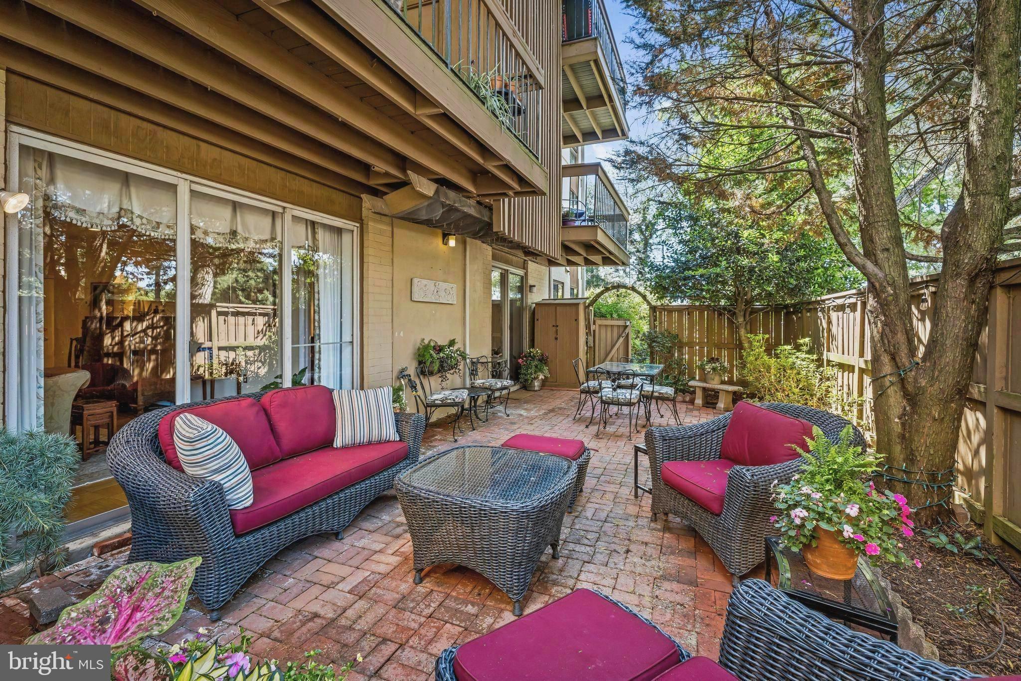 More than you could ever dream of in a condominium.  If you long for one level,  low maintenance living but you aren't ready to give up your outdoor space then this is for you. If you desire charming, spacious , multi-purpose rooms with custom built-ins, crown moldings and iconic wood parquet floors then this is for you. 
If you would enjoy a quiet location only moments away from exciting new restaurants, retail stores, specialty ice cream and pastry shops, cosmetics, eyeglasses, luxury linens, closet design...then this is definitely for you.
The magic begins as you open your private gate to your fenced 35'x15' brick patio. The patio is bordered by planting beds containing multiple kinds of perrenial flowers and greenery. Potted plants provide pops of colorful annual flowers. 
Inside the sliding glass doors you'll find a multi-purpose family room with custom built-ins and dining area.
All floors, except baths and kitchen, are Cross Keys iconic wood parquet. A timeless white kitchen with a suite of stainless appliances and quartz counters. The living room is spectacular with it's nod to gracious entertaining,  built-ins and glass doors overlooking the garden.
The primary bedroom is serenity with interior shutters and space to wind down from the day. En-suite primary bath features large shower with glass doors. Two more generous  size bedrooms are replete with their own baths.