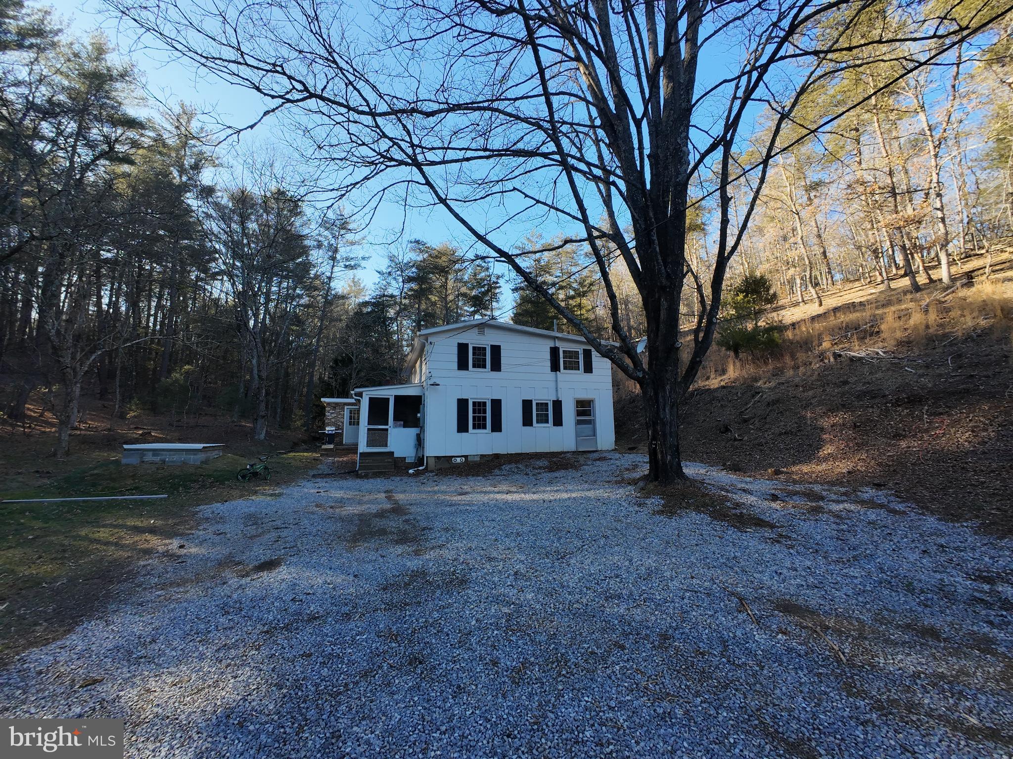 Welcome to a nature lovers paradise! Situated on 27 acres this 4-bedroom, one bath home provides seclusion within 30 minutes of the town of Broadway. The property features acres of wooded land along with a meadow perfect for gardening. There is a stream that runs alongside the home to enjoy peaceful evenings on the screened in porch. The kitchen features granite countertops, a gas range, and a woodstove! On the main level there are 2 living areas, a laundry/mud room, full bathroom and bedroom. Upstairs you will find an additional 3 bedrooms and loft area. The exterior of the home features numerous outbuildings, one equipped with electrical service. Call today for a showing of this beautiful property!