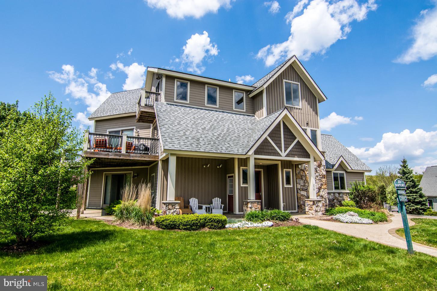 Perfectly located for enjoying Deep Creek Lake in every season, this stunning 5-bedroom, 4.5-bath mountain, lake retreat offers the ideal blend of comfort, convenience, and investment potential. Step out the back door and head to your dedicated dock slip for a day on the lake, then take in the views of Wisp Ski Resort just across the street!

Designed for gathering, the home features an open kitchen, dining, and living area highlighted by a soaring vaulted wood ceiling and a dramatic floor-to-ceiling stone fireplace. With three primary suites, including two upper-level primary bedrooms with private balconies, there’s plenty of space for family and guests to relax in comfort.

The lower level is built for entertaining with a spacious family room, wet bar, pool table, and a separate game room. Currently a strong vacation rental, this property offers an excellent opportunity to enjoy your own Deep Creek getaway while generating rental income. An unbeatable location with lake access, ski views, and year-round recreation at your doorstep! Truly "Location, Location, Location"