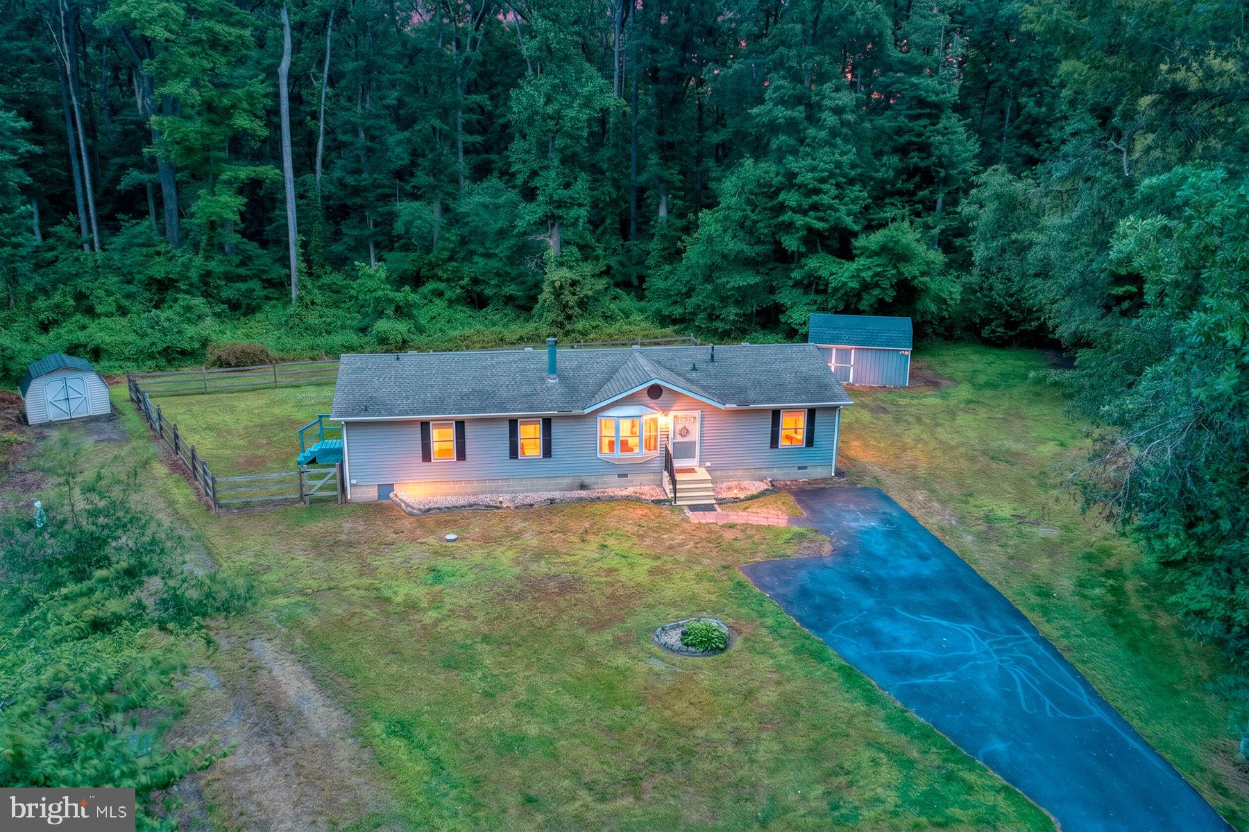 Welcome home to the perfect blend of privacy, comfort, and modern updates. Situated on a spacious 0.40-acre lot with no HOA, this beautifully updated property offers a wooded backdrop, ample space for recreational vehicles, boats, trailers, and all your outdoor lifestyle needs, while still being conveniently located just minutes from town.
Step inside to discover a bright and inviting open-concept living and dining area featuring a cozy fireplace with a brand-new gas insert and stunning LifeProof 30-mil luxury flooring. The spacious layout provides the ideal setting for both entertaining guests and everyday living.
The generously sized kitchen offers an abundance of cabinet storage, a center island, and plenty of workspace for meal preparation and gathering with family and friends. Adjacent to the kitchen, you'll find a convenient laundry room with direct access to the backyard.
Throughout the home, the durable LifeProof flooring continues seamlessly into each bedroom. The owner's suite serves as a private retreat, complete with a beautiful en-suite bathroom designed with comfort and style in mind. Each bedroom is equipped with a ceiling fan for year-round comfort. The home also includes a flexible bonus room, offering endless possibilities as a home office, guest suite, reading room, hobby space, or additional living area tailored to your lifestyle.
Outdoor living is equally impressive. Enjoy peaceful mornings or relaxing evenings on the rear deck overlooking the wooded surroundings. Two storage sheds are included, providing plenty of space for tools, equipment, and hobbies.
This home has been extensively updated for peace of mind, including:
Brand-new windows throughout the home
New window blinds
Roof replaced in 2020
HVAC system installed in 2018
New water heater
Water softener system 2024
Chlorine feeder system 
As an added bonus, the seller is including a one-year home warranty from APHW, a $499 value.
With no HOA, numerous major updates, wooded privacy, and room to spread out, this move-in-ready property offers exceptional value and is ready for its next owner to call it home.