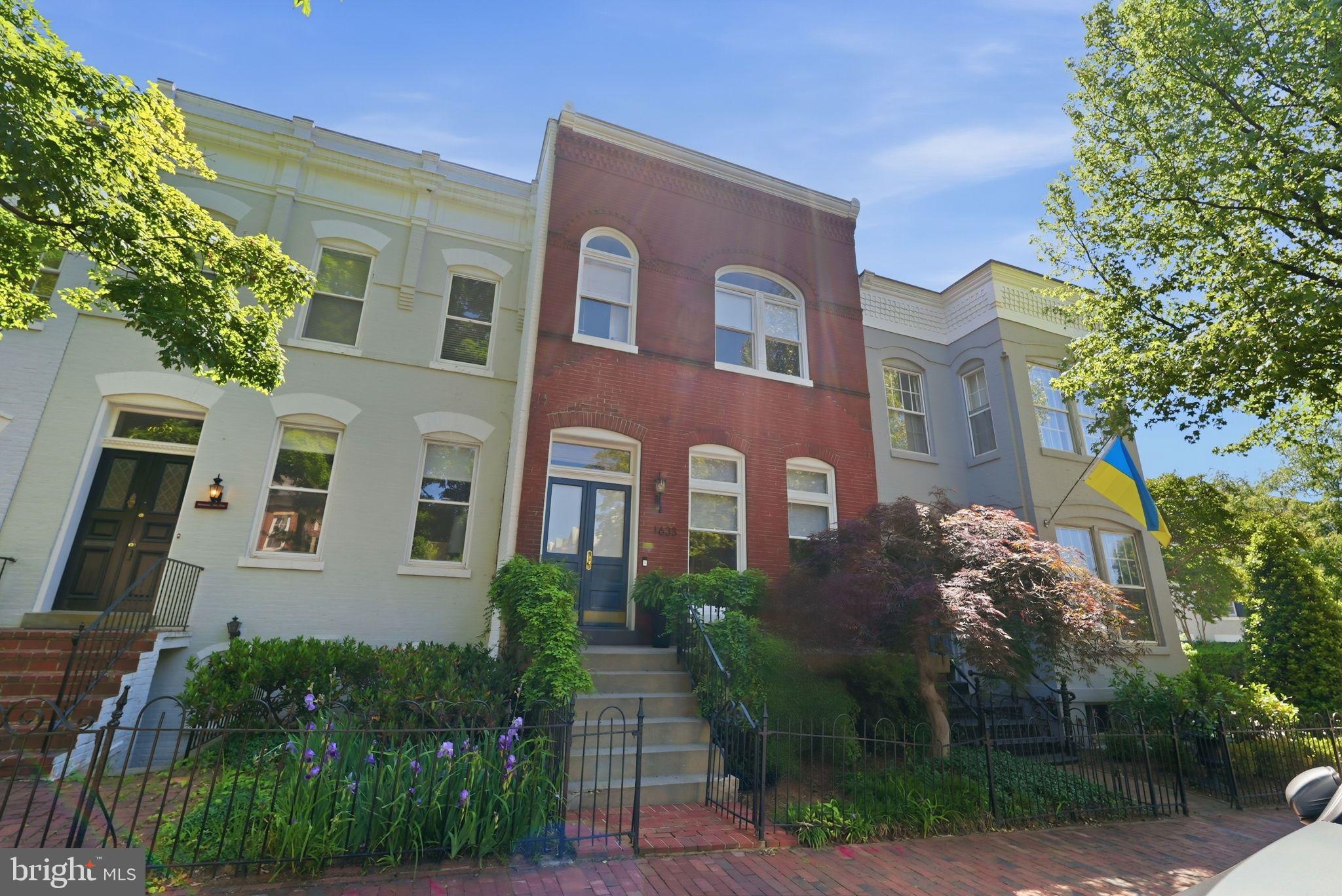 NEW LISTING! Don’t miss this incredibly rare offering featuring a coveted oversized garage with flexible studio space above. This beautifully updated three-story home is located in Georgetown’s sought-after West Village neighborhood and offers soaring ceilings, a newly renovated designer chef’s kitchen, refinished hardwood floors, exceptional scale, and charming private outdoor space. The residence features 3 Bedrooms, 2 Full Bathrooms, 1 Half Bathroom, and approximately 3,800 square feet of combined updated living space. Filled with warmth and character, the home showcases oversized windows that flood the interiors with natural light, custom crown molding, and impressively proportioned rooms designed for both elegant entertaining and comfortable everyday living. The main level is anchored by a gracious Living Room with soaring ceilings, a fireplace, and original sliding pocket doors, all illuminated by afternoon sunlight streaming through west-facing windows. The expansive formal Dining Room easily accommodates gatherings of any size and features a second fireplace, crown moldings, designer lighting, and abundant natural light. The recently renovated Chef’s Kitchen is outfitted with top-of-the-line appliances, custom cabinetry, designer backsplash, and a spacious eat-in breakfast area complete with built-in storage. Upstairs, the gracious Primary Suite features custom crown moldings, a third fireplace, and a beautifully updated spa-inspired Bathroom. Two additional Bedrooms, a generously sized Hall Bathroom, and a versatile bonus room complete the upper level. The Lower Level offers a spacious Recreation Room with walk-out access to the private rear courtyard garden, along with a full-size laundry area and abundant storage space. This exceptional home is further enhanced by a private rear courtyard, rare garage parking, and a versatile accessory unit above the garage, offering incredible flexibility for use as a guest suite, fitness studio, or home office. OPEN SUNDAY, 5/17 from 2–4PM!