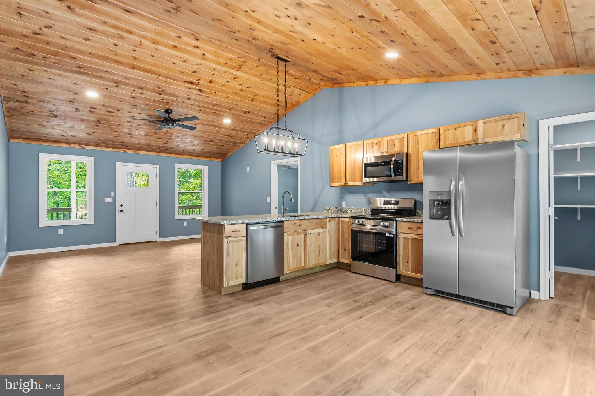 Tucked among the trees in Basye, this newly constructed ranch home offers a turnkey opportunity for first time home owners, downsizing, or investors.  With easy one-level living, modern finishes, and close proximity to year-round recreation, this property is well-positioned as a personal getaway, full-time residence, or potential short-term rental investment.

Inside, the bright open-concept layout features beautiful wood paneled, vaulted ceilings and an inviting flow between the living area and kitchen — creating a comfortable space for relaxing after a day outdoors or hosting weekend guests. Contemporary finishes throughout provide a clean, modern feel, while the private primary suite includes a beautifully tiled shower. Two additional bedrooms and a thoughtfully designed layout make the home comfortable for everyday living or accommodating overnight guests.

The surrounding area offers four-season outdoor recreation and a peaceful mountain setting that continues to attract vacation-home buyers and outdoor enthusiasts alike. Located 12 minutes from Bryce Resort, owners and guests can enjoy skiing, snowboarding, mountain biking, golf, lake activities, hiking trails, fishing, and more throughout the year.

Whether you're searching for a weekend escape, an income-producing property, or a peaceful place to unwind, this move-in-ready home delivers modern comfort in an adventure-filled location.