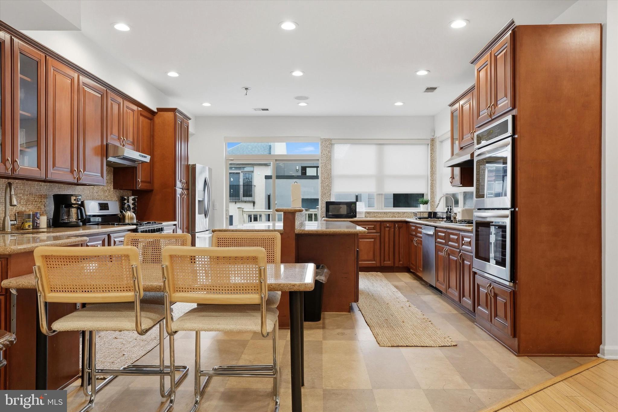 Legally zoned and successfully run as an Airbnb, 1011 N Orianna Street presents a rare opportunity to own an exceptionally large new-build from 2009, offering over 5,000 square feet of living space with extraordinary flexibility. Configured with 8 bedrooms and 5.5 bathrooms, the home features multiple living areas, two full kitchens, and a lower-level kitchenette, creating an ideal setup for intergenerational living, large households seeking privacy within a shared home, or buyers looking to continue operating a high-performing short-term rental investment that is on Airbnb and VRBO. The thoughtful layout allows the property to function almost like several homes under one roof. The main level includes a spacious kitchen, living and dining areas, two bedrooms, and access to a rear deck and shared patio. The finished lower level provides additional living space with a kitchenette, two bedrooms, a full bathroom, and direct patio access. The second floor offers another kitchen, multiple living areas, a dining space, and a half bath, while the upper level contains four additional bedrooms, including a primary suite with an ensuite bath, plus convenient second-floor laundry. Multiple gathering areas and kitchens allow residents or guests to spread out comfortably while still enjoying shared spaces. Just steps from the vibrant restaurants, cafés, parks, and boutiques that define Northern Liberties, the home offers easy access to Old City, Center City, and major cultural destinations, including the Philadelphia Museum of Art and The Franklin Institute. With its scale, flexible layout, and prime location in one of Philadelphia’s most dynamic neighborhoods, 1011 N Orianna Street represents a unique opportunity for both homeowners and investors alike. Airbnb furnishings are negotiable. Available for immediate purchase; occupancy is subject to confirmed bookings at the time of the offer.