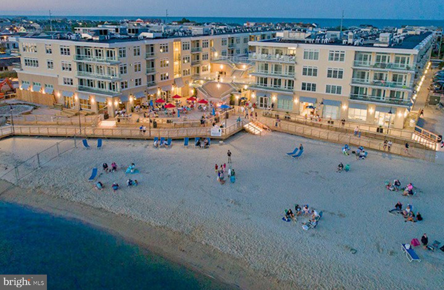 Welcome to Unit 463 of The Residences of Lighthouse Cove, a stunning 3-bedroom, 2.5-bath bayfront penthouse offering 1,696 square feet of thoughtfully designed living space and a 251-square-foot balcony with sweeping views of Rehoboth Bay. Sold fully furnished, this home is move-in ready and perfectly suited for a refined coastal lifestyle. The open-concept design with 9' ceilings (4th floor only) features a modern kitchen with a large island that flows seamlessly into the dining and living areas, all opening onto the oversized balcony—an ideal setting for sunset cocktails or outdoor dining with a view. The tranquil primary suite provides a private retreat with bay views, while two additional bedrooms offer comfort for family and guests. As part of The Residences of Lighthouse Cove, owners enjoy premier amenities including a rooftop pool and plaza with fire pits, grilling stations, and lounge areas, a fitness center, and on-site dining at the Lighthouse Restaurant—all directly on the bay with opportunities for water sports and boating. Just steps from Dewey Beach’s wide sandy shoreline and lively restaurants, and minutes from Rehoboth’s award-winning dining, boutique shopping, and iconic boardwalk, Unit 463 presents a rare chance to own a turn-key, fully furnished bayfront home in one of the Delaware coast’s most sought-after communities—where every day feels like vacation.