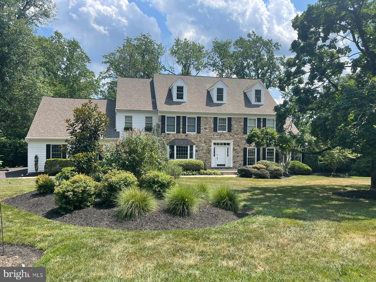 Interior pictures to be by 7/22!  Step into luxury at this stunning three-story Colonial nestled on 2.2 acres in the prestigious Pennock Woods. The exterior boasts a charming blend of stone and wood siding, offering exceptional curb appeal.

Upon entering the foyer, hardwood floors guide you through the main level, where elegance and functionality blend seamlessly. To the right, the formal living room impresses with dental crown molding, chair rails, and hardwood floors. French doors lead to a sun-soaked sunroom with tile flooring, two skylights, and expansive windows overlooking the wooded backyard. A second set of French doors opens onto a deck, perfect for enjoying the natural surroundings.

The formal dining room is designed for memorable gatherings, featuring hardwood floors, dental crown molding, and a chair rail. Adjacent is the inviting two-story family room, highlighted by a floor-to-ceiling stone wood-burning fireplace. Imagine cozy evenings with a favorite book or hosting guests in this captivating space. French doors open to a deck with views of the tranquil woods, while a balcony above offers a retreat with custom bookcases.

The gourmet kitchen is a chef's dream, featuring hardwood floors, white cabinets (some with glass fronts), custom tile backsplash, and granite countertops—including a spacious island. High-end appliances ensure effortless meal preparation, while a sliding glass door leads to another deck shaded by an electric remote awning, perfect for outdoor dining and relaxation.

Conveniently located on the main level with its own entrance, an office/bedroom and full bath provide flexibility, ideal for guests or an in-law suite. An oversized three-car garage offers ample space for vehicles and storage needs.

Ascending the wooden staircase to the second level reveals new hardwood floors throughout the hallway. The expansive master suite beckons with vaulted ceilings, a gas fireplace, and a private balcony overlooking the serene backyard. A large walk-in closet provides plenty of storage, while the luxurious en suite bathroom features double sinks, a spacious stall shower, jacuzzi, and tile flooring. Three additional bedrooms, one with its own bath, ensure comfort and privacy for family and guests. The hall bath boasts double sinks and a spa-like bath/shower surrounded by porcelain tile.

Convenience meets luxury with a large laundry room on the second floor, making household chores a breeze. The third floor offers a versatile loft area with skylights, wood beams, built-in benches, double cedar closets, and attic access—a perfect space for hobbies or relaxation.

The walkout lower level is an entertainment haven, featuring granite countertops in the desk area, a billiard room, and a family room with a gas stove—a perfect spot for casual gatherings. A bedroom with a full bath completes this level, providing additional comfort and privacy.

Experience unparalleled luxury in the serene setting of Pennock Woods, where this meticulously designed residence offers the ultimate blend of comfort, style, and sophistication.