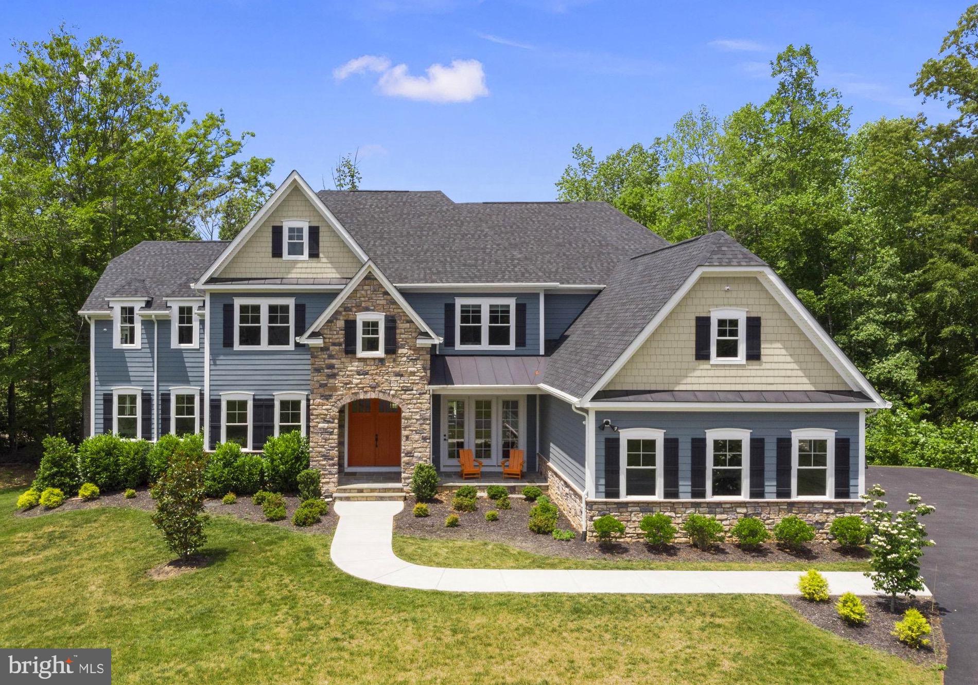 Located in the desired Noah’s Landing community on the exclusive private side of Lake Anna, this extraordinary lakefront masterpiece is a tribute to luxury, merging expansive design and thoughtful amenities to create an exceptional waterfront lifestyle.  Completely furnished and set along a quiet cove with a private white sandy beach, Adirondack chairs, and your very own boat dock, this property offers elevated outdoor living at both the shoreline and the home -- across five decks and patios—ideal for taking in sweeping water views, entertaining with ease, or enjoying quiet mornings by the lake.  Spanning approximately 8,000 square feet, the home is designed for both comfort and scale, featuring 9 bedrooms, 7 full bathrooms (6 en suite), and two additional powder rooms. At the heart of the home, a stunning great room with high vaulted ceilings features floor-to-ceiling windows that showcase breathtaking views of Lake Anna, filling the space with natural light. A fireplace with a refined mantle and custom built-in bookcases anchors the great room, creating a warm and inviting gathering space. The cavernous chef’s kitchen is equally well-appointed with granite countertops, double islands (one with bar seating for 7), stainless steel appliances, double ovens, double microwaves, dual refrigerators, two dishwashers, and generous prep space, seamlessly connecting the main living and dining areas.  The main level also features two bedrooms, including the large primary suite; one of these is set up as an office.  Upstairs, the expansive second level features five additional bedrooms and more deck space, perfect for large family gatherings and entertaining.  The finished lower level enhances the home’s versatility with a massive recreation area, wet bar, movie room featuring a 110-inch projection screen with immersive surround sound, another bedroom, and a game room (or additional bedroom) designed for year-round enjoyment.  Oversized four-car attached garage, and a fifth storage garage accessible from the back of the house, perfect for storing jet skis, lawn equipment, etc.  Outside, the large flat backyard invites recreation and relaxation, complemented by a basketball hoop, portable soccer goals, and nearby community courts for tennis and pickleball. Ideally located, the home is just a short drive to groceries, popular local dining like El Gran Patron, The Lake Anna Taphouse, Coffee and Creamery, and other everyday conveniences, while offering easy access to Richmond, Fredericksburg, and Charlottesville—each approximately 45 minutes away—and roughly 80 miles south of Washington, DC. With high-speed fiber internet available and a setting that balances privacy with accessibility, this property also presents a compelling investment opportunity in a community that permits it, alongside its appeal as a refined full-time residence or private lakefront retreat.  INVESTORS: the top Lake Anna property manager forecasts this property could generate $300,000 per year in rental income (see pro forma documents section)!