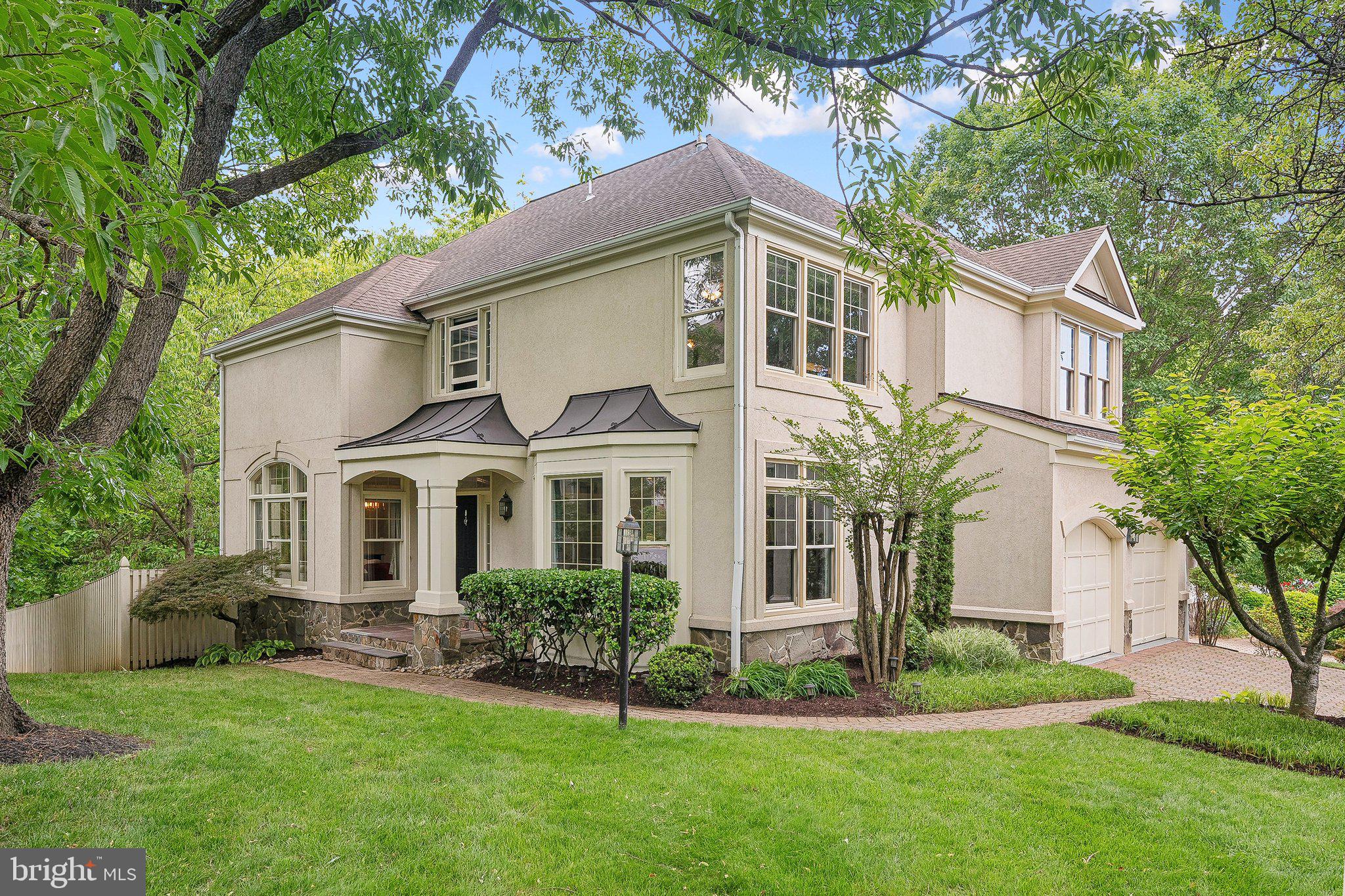 **Open Houses Canceled** Stunning 5BR/4.5BA residence in coveted Edgemoore community. Tucked away in the serene enclave of Edgemoore, this beautifully updated home offers a seamless blend of modern luxury and timeless charm, set against a picturesque backdrop of lush greenery and a tranquil stream. Step inside to an elegant open-concept layout complemented by classic living spaces, including a formal dining room, welcoming living area, and a cozy den/library. The dramatic two-story family room features custom built-ins, a gas fireplace, and a statement chandelier, creating a warm yet sophisticated ambiance. At the heart of the home, the recently renovated kitchen is a showstopper. Highlights include a striking waterfall island, quartz countertops, abundant cabinetry, gas range, and more—ideal for both everyday living and entertaining. Step outside to the Trex deck and soak in the serene natural surroundings—perfect for morning coffee or evening gatherings. Upstairs, you'll find four generously sized bedrooms. The luxurious primary suite features two well-appointed closets and a spa-like en-suite bath with dual vanities and a soaking tub. Laundry has been conveniently relocated here. A secondary bedroom with its own en-suite is ideal for guests, while two additional bedrooms at the rear of the home are bathed in natural afternoon light.  Finished walkout basement includes a spacious recreation area with plush carpeting, a wet bar, and a projector with screen (both convey). A fifth bedroom and full bath offer flexible living options. Sliding doors lead to a paver patio and fully fenced backyard oasis. Ideally located less than 1.5 miles from Vienna Metro, with easy access to I-66, Oakton High School, local shops, and downtown Vienna—this home effortlessly combines comfort, style, and convenience.