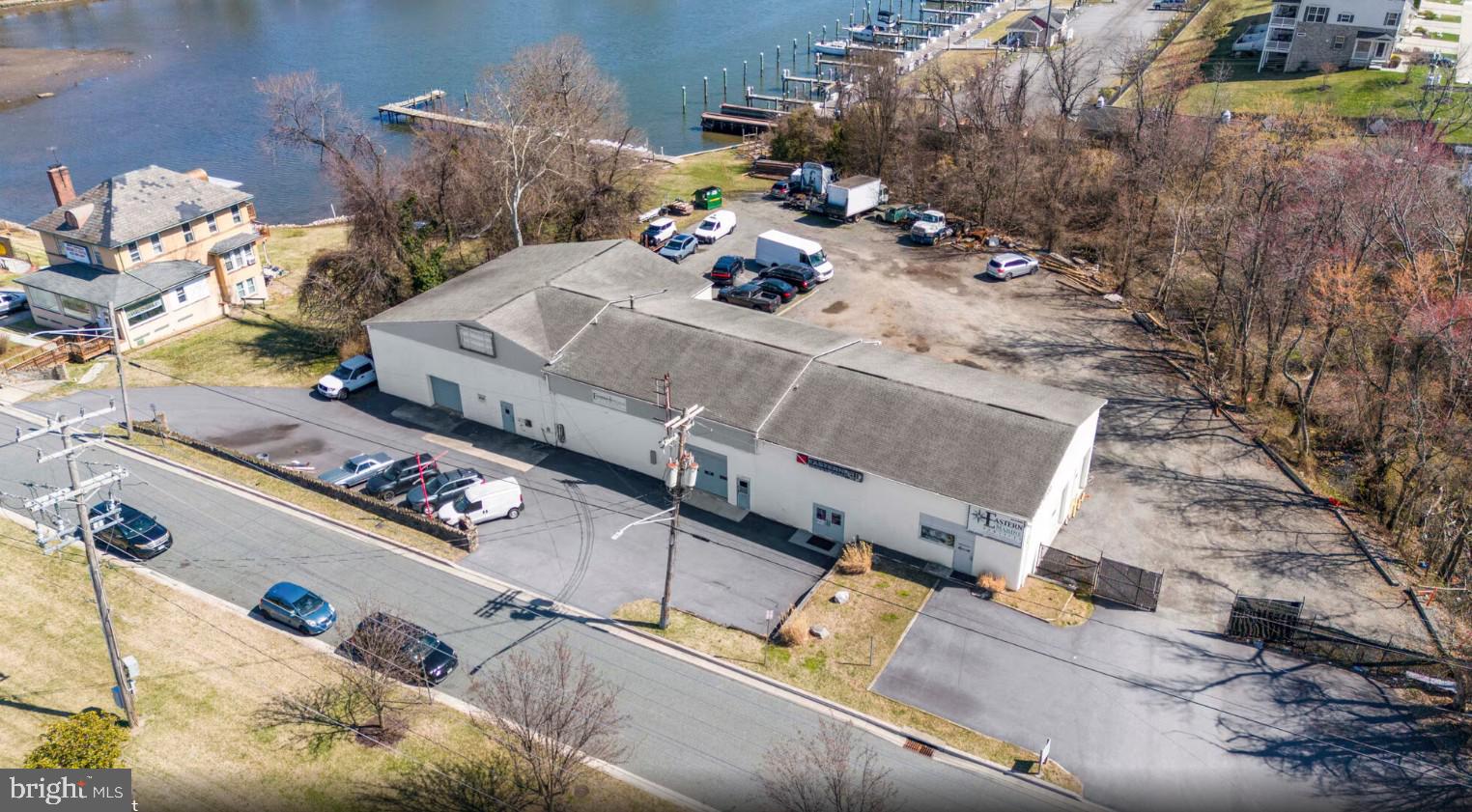 Zoned Commercial Industrial| ±6,936 Sq. Ft. | 2.024 Acres | 148’ Waterfront Available for purchase!  Discover a rare waterfront commercial opportunity at tip of the vibrant shore of Middle River. This prime 2.024-acre parcel features 148 feet of direct waterfront and is zoned Commercial Industrial, offering exceptional flexibility for marine-based operations, investment, or redevelopment. The 6,936 sq. ft. facility includes seven (7) oversized bay doors, a recently replaced roof, and a newly paved blacktop lot providing ample parking and easy maneuverability for equipment and vehicles. With mean water depths of 5 feet (3 feet at low tide), the site is well-suited for boat service, storage, or waterfront access businesses.
The property offers a turnkey investment with steady cash flow and future expansion potential, underscoring its desirability within the marine and industrial community.  Whether you’re seeking to expand your marine enterprise, establish a waterfront commercial hub, or secure a valuable income-producing asset, 1923 Old Eastern Avenue stands as one of the most versatile and strategically positioned waterfront holdings in Baltimore County.