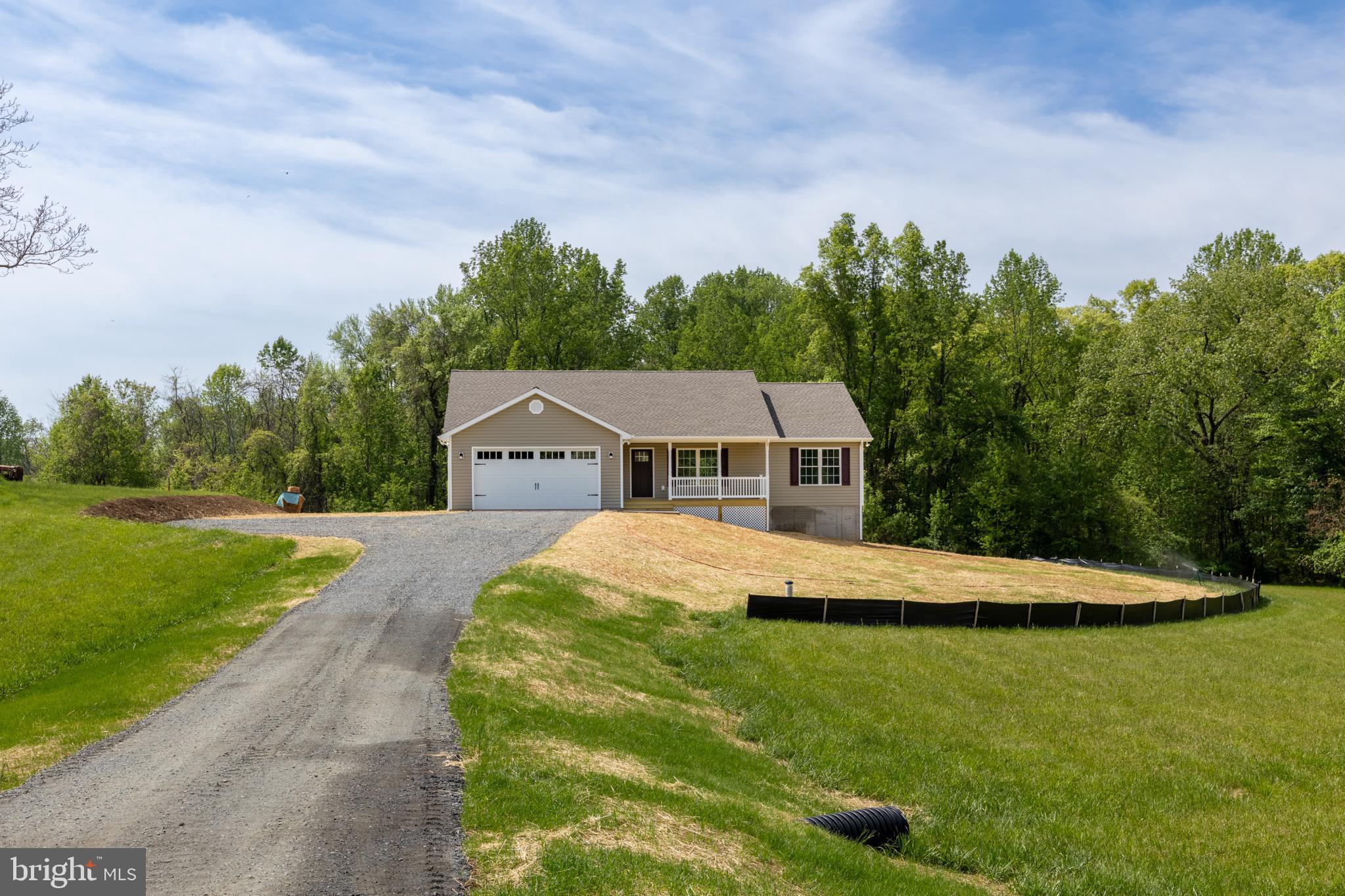 Opportunity to own a brand new home in beautiful Madison County! Ranch style home boasts a split bedroom floor plan with 3BRs/2BA, luxury vinyl plank throughout, granite countertops, open concept great room w/cathedral ceiling & recessed lighting, separate laundry room w/barn door & more! Full walkout basement offers plenty of potential with space for rooms, rough-in plumbing & large windows allowing for plenty of natural light. Also included is an attached 2-car garage. Enjoy the outdoors from the covered front porch or rear deck overlooking the sprawling yard backed by wooded privacy.  Quality craftsmanship & details show throughout with wide trim-work, rounded edge walls, upgraded finishes, etc. This adorable home is situated on 3+ acres just off Route 230 East with an ideal location for traveling to the town of Madison, Orange, Culpeper &/or Charlottesville. Just Pack Your Things & Move Right In!!