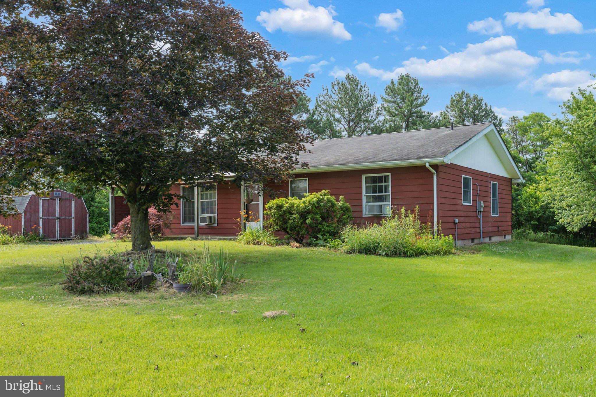 Opportunity knocks! This estate sale property offers tremendous potential for the right buyer. Situated on a peaceful 2.5-acre lot, this one-level, two-bedroom, two full-bath home backs to trees — with approximately ¾ of an acre of wooded land on the property — providing privacy and a serene natural setting. The home features classic hardwood floors and a lovely screened-in patio, perfect for enjoying the outdoors. A covered carport with exterior storage adds everyday convenience, and two detached sheds offer excellent additional storage or workshop space. Sold strictly as is, this property is ideal for investors, flippers, or buyers looking to customize a home to their own taste. With the right vision and updates, this could be a truly special property. Don't miss this chance to own acreage with great bones at an accessible price point.