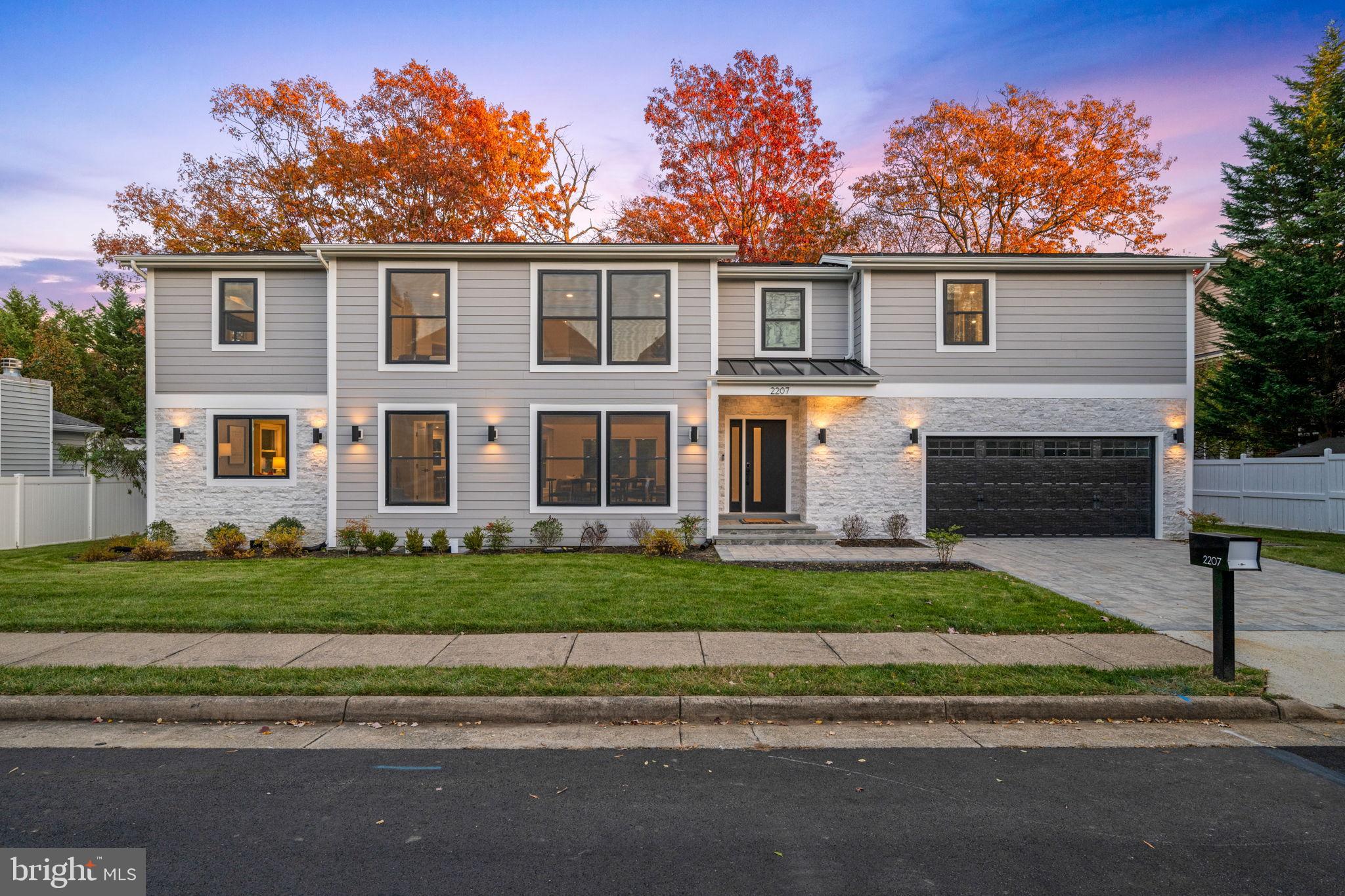 Welcome to 2207 Arden Street—a fully re-imagined contemporary Craftsman in the heart of Tysons/Dunn Loring. Redesigned and rebuilt in 2023 by the owner and design team, this residence blends modern elegance, function, and convenience. With 6 bedrooms, 5.5 baths, an attached garage, and backing to trees, the home is made for both entertaining and easy daily living.

MAIN LEVEL – ENTERTAIN WITH EASE
A wide, light‑filled foyer opens to a dramatic two‑story family room anchored by a sleek fireplace and oversized windows that flood the space with light. The open plan connects living, dining, and kitchen areas for effortless gatherings. The chef’s kitchen features custom cabinetry, premium appliances, a statement center island, and a walk‑in pantry—equally ready for a quiet breakfast or a lively dinner. A dedicated home office sits just off the main flow for work or study.

SECOND LEVEL – QUIET LUXURY
Upstairs, the primary retreat invites rest with a generous bedroom, private balcony, and a spa bath with soaking tub, large glass‑enclosed shower, and dual vanities. A custom walk‑in closet completes the suite. Two additional en‑suite bedrooms offer privacy for guests or multi-generational living, while two more bedrooms share a well‑appointed hall bath. A laundry room on the bedroom level keeps routines simple. The open landing overlooks the family room, enhancing volume and light.

LOWER LEVEL – THE ENTERTAINMENT HUB
The expansive lower level is designed for play and relaxation: a game/TV zone flows to a wall‑length wet bar with double‑door under‑counter beverage fridge—perfect for movie night or game day. A private bedroom and full bath serve visiting guests or an au pair, while walk‑out stairs offer direct access to the yard.

OUTDOOR LIVING – PRIVATE AND POLISHED
Thoughtful hardscaping ties the interior to the outdoors: a stone patio and stone walkways from all exterior doors connect to manicured grounds with a serene, wooded backdrop—ideal for al fresco dining, morning coffee, or a quiet evening unwind. Mature trees create a sense of privacy rarely found this close to Tysons.

MATERIALS AND MAJOR IMPROVEMENTS – PEACE OF MIND
A comprehensive renovation was completed in 2023: layout redesign, extensions, structural framing, new walls, plumbing, electrical, mechanical systems, and roof. Finishes includes hardwoods, contemporary stone and Hardie sidings, and designer lighting. The result is a like‑new home that lives beautifully today and for years to come.

LOCATION – AT THE CENTER OF IT ALL
On a quiet street, this address offers easy access: Tysons Corner Center, Tysons Galleria, and Mosaic District are minutes away for dining, shopping, and entertainment. Commuting is simple with I‑495, I‑66, Route 7, and the Silver Line Metro and Orange Line Metro nearby. Enjoy weekend rides on the W\&OD Trail or explore neighborhood parks and recreation.

FUNCTION MEETS FLEXIBILITY
The layout supports work‑from‑home, multi-generational living, and frequent hosting, with generous storage and smart circulation throughout. The home shows as a polished primary residence, and current Fairfax County short‑term rental license (STL‑2023‑00075) documentation is available upon request for buyers who value optionality.

WHAT CONVEYS
All kitchen appliances, washer and dryer, existing light fixtures and ceiling fans, window treatments, garage door openers/remotes, and the lower‑level beverage fridge. Furnishings available separately via an optional package—ask for the complete inventory.

THE LIFESTYLE
Modern design, indoor‑outdoor flow, and proximity to business and cultural hubs—without sacrificing a neighborhood feel. If you’ve been waiting for a turn‑key Tysons/Dunn Loring home that balances polish with practicality, your search ends at 2207 Arden Street.