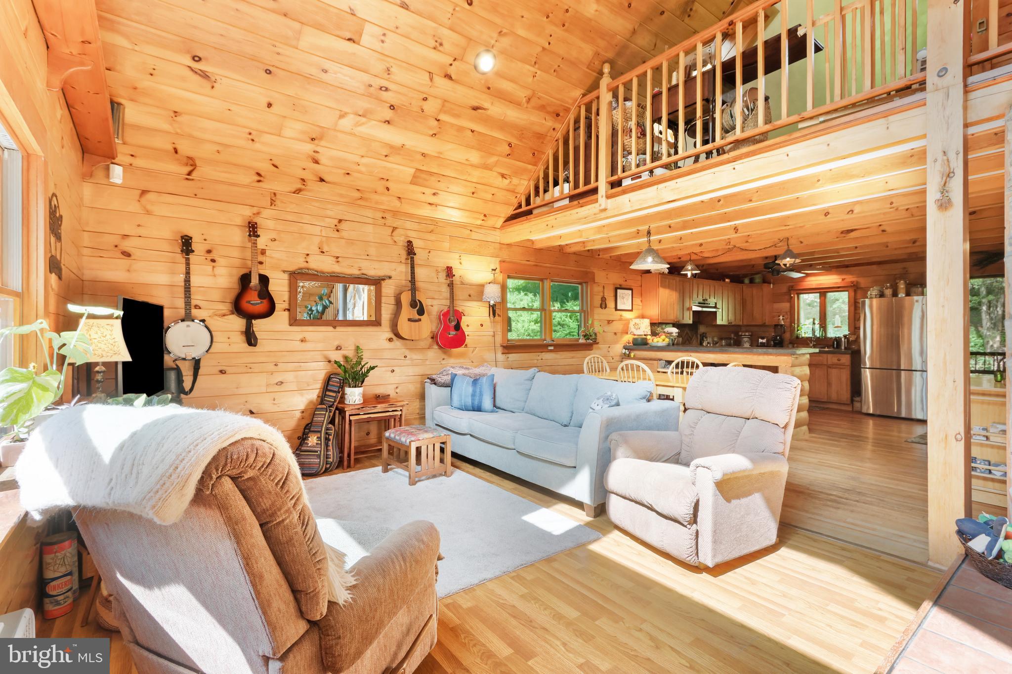 Ultimate Privacy Meets Pocono Adventure! Escape the everyday in this secluded log chalet nestled on 3.26 wooded acres in Beltzville Lake Estates. Backing to an adjacent 500+ acres of privately owned, wildlife-filled woodland, this rare retreat offers exceptional privacy, peaceful natural views, and a serene mountain setting. Step out onto the rear deck to enjoy the sights and sounds of nature. Inside, you'll find soaring cathedral ceilings, two cozy wood stoves, hard-surface flooring throughout, and an open-concept layout with stainless steel appliances. The sunlit primary bedroom features skylights, while the finished lower-level family room provides additional space to relax or entertain. Just minutes from Beltzville Lake, Hickory Run and Lehigh Gorge State Parks, historic Jim Thorpe, hiking, biking, whitewater rafting, and year-round Pocono recreation, this home offers the perfect balance of secluded mountain living and convenient access to the region's top outdoor destinations. Ask how to receive up to $5,000 lender credit towards closing costs or lowering your interest rate!