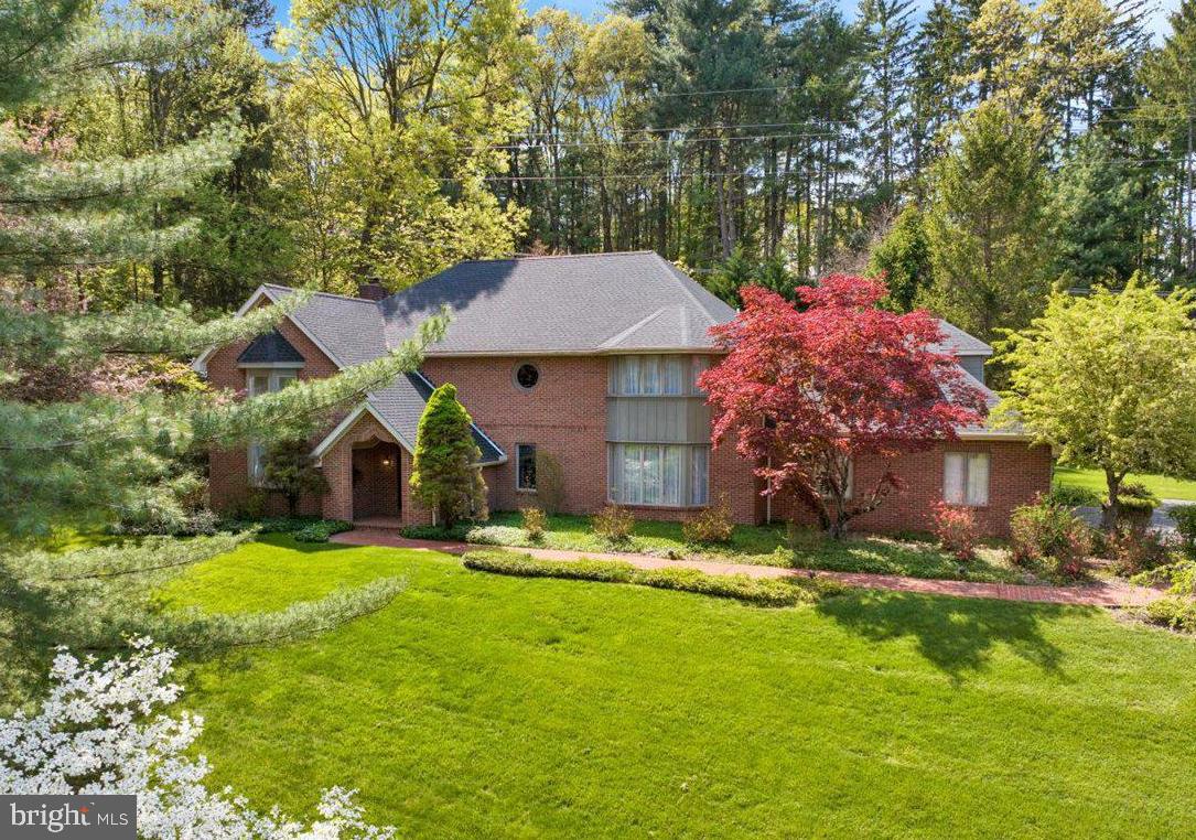 Searching for a spacious, quality-built home in a tranquil, nature-filled setting? This exceptional Doug Young built Contemporary residence in the prestigious Hessian Pines community offers over 4,400 square feet of above ground living space and is ready to welcome its next owner. A grand two-story foyer sets the tone upon entry, showcasing a sweeping curved staircase and an elegant chandelier. The foyer opens to a dramatic two-story formal living room, where a wall of windows fills the space with natural light and creates an impressive, airy ambiance. The formal dining room features oversized windows and mirrored walls making this space feel even larger and perfect for entertaining. The well-appointed chef’s kitchen is designed for both functionality and style, offering abundant high-quality cabinetry, double ovens, and a generous peninsula. It flows seamlessly into the 23x11 sunroom addition, highlighted by exposed brick walls and serene views of the private patio and beautifully landscaped backyard. The main level is completed by a spacious great room with a wood-burning fireplace, custom built-ins, and two sets of double glass doors providing direct outdoor access, along with a conveniently located powder room. Upstairs, an impressive 18x17 office overlooks the living room below and features stained glass accents and custom built-ins. The luxurious primary suite offers a 20x14 bedroom, a private bath, and a large walk-in closet. Two additional generously sized bedroom suites, each with their own full bathroom, provide comfort and privacy for family or guests. Situated on 2.87 acres, the property offers potential for subdivision, with the possibility of an additional building lot to the right of the driveway. Whether you envision adding a pool or creating expanded outdoor living or recreational spaces, the possibilities are abundant. Ideally located just minutes from major routes, this home provides a convenient commuter location while remaining privately tucked away in a peaceful, partially wooded setting enhanced by mature landscaping. Schedule your private showing today!