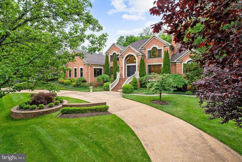 Tucked away on a quiet cul-de-sac in the heart of McLean, this spectacular gated estate has been completely reimagined to deliver the ultimate blend of privacy, sophistication, and modern luxury—just minutes from Tysons Corner and Washington, D.C.

A meticulous renovation transformed every space with curated materials and finishes including Pella windows, custom doors, designer lighting, and bespoke architectural details throughout.

At the center of the home, the stunning kitchen serves as both showpiece and gathering place. Equipped with SubZero refrigeration, a Wolf range, Sharp microwave drawer, Zip water system, and a striking climate-controlled wine display, the space flows effortlessly into the dining area and an extraordinary great room with soaring 20-foot ceilings and a dramatic fireplace overlooking the pool and gardens.

Designed for both entertaining and everyday luxury, the home also features a formal dining room, an elegant living room with fireplace, and a private glass-enclosed library with tranquil views of the resort-style backyard.

The main-level primary suite is a retreat of exceptional scale, complete with dual couture-inspired dressing rooms and a spa-like bath with dual vanities. Expansive windows frame views of the landscaped gardens and pool.

Upstairs, three bedroom suites feature cathedral ceilings, designer accents, and skylit baths, while a luxurious guest suite offers the flexibility of a second primary.

The walk-out lower level introduces an entirely separate in-law residence with private entrance, kitchenette, living area, and full bath, along with a professional gym, recreation room, and game room.

Outside, the property transforms into a private resort with recently installed heated saltwater infinity-edge pool and spa by Lewis-Aquatec surrounded by lush landscaping.

Modern conveniences include a three-car garage with Tesla chargers, Generac generator, commercial-grade WiFi, integrated security system, enhanced exterior lighting, and fully gated grounds.

This extraordinary residence offers a rare opportunity to own a completely turnkey estate in one of McLean’s most prestigious enclaves.