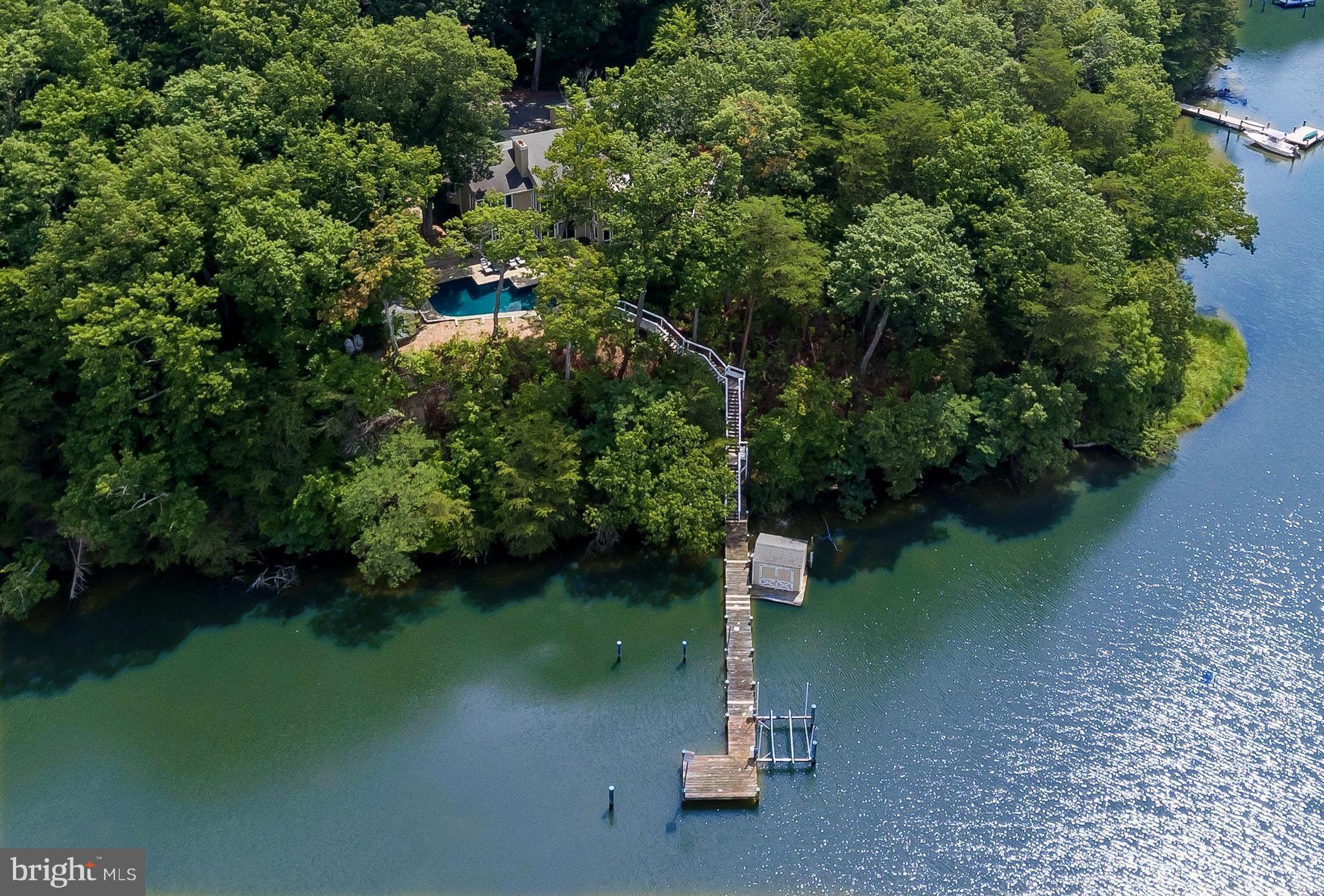 Distinctive Greco custom contemporary on 2+ acre point of land with 320' tree-lined drive and 388' on the water / Private pier on Beards Creek (to the South River) with 10,000 lb boat lift, PWC hoist in boathouse, plus 2nd deep water slip / Waterside heated gunite pool / Generous social spaces with lofty ceilings, abundant windows and sweeping views from almost every room! / 3 fireplaces /