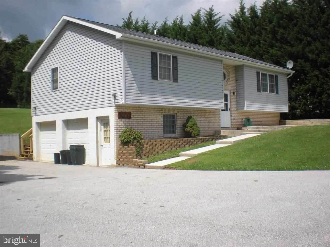 Looking for country living?  This split foyer home with ceramic tile steps lead to 3 bedrooms and 2.5 baths.  Large eat-in kitchen with all appliances.  Laundry area off kitchen.  Newly finished room in back could be family room or sun room.  2 car garage.  Propane FHA heat with electric baseboard for back up.  New large deck.  Above ground pool.