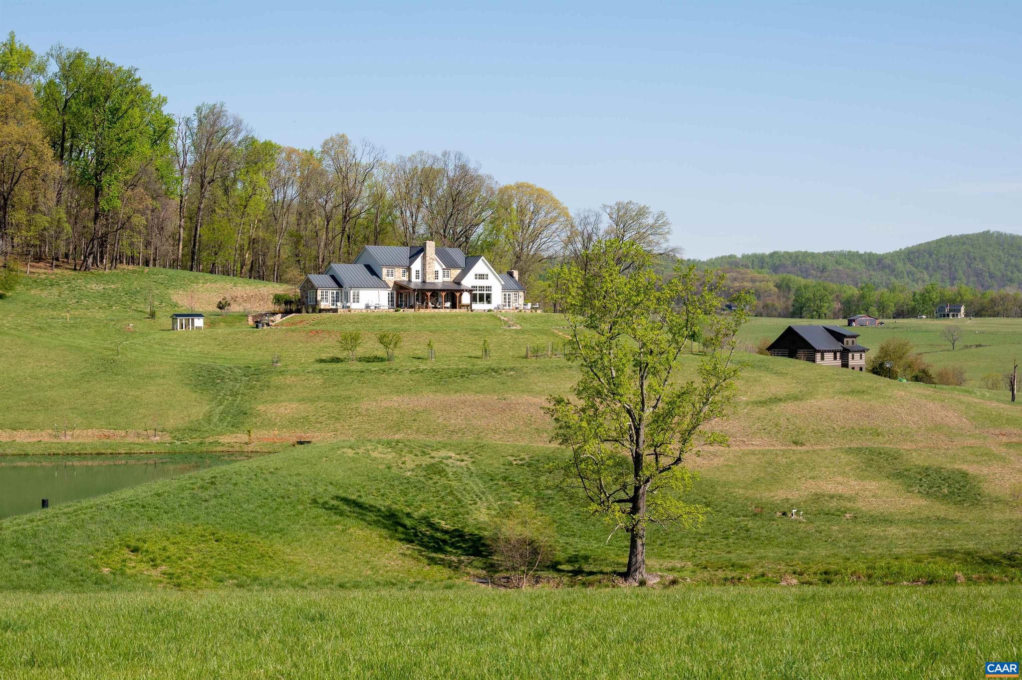Entered in for Comp Purposes.  This magazine worthy farmhouse is perfectly sited on over 156 protected acres overlooking a pond and the rolling hills of Southern Albemarle. With dramatic yet warm and welcoming interior spaces, this home is truly stunning! 4 bedroom, 4 full and 2 half baths, gorgeous professional kitchen, luxurious his and her primary bathrooms, a cozy den, and a light-filled great room with dramatic cathedral ceiling and post and beam architectural feature. The owners' uncompromising standards and attention to detail are evident both inside and out with features including shiplap interior walls, beautiful hand-hewn timber on cathedral ceiling, posts and beams, stone fireplaces, stone front facade, covered rear patio with exterior fireplace, and superior quality materials and finishes throughout. Enhancing the main residence is a charming log "barn" with full kitchen, bedroom, bathroom and tons of open space which could be used for an office, recreation, guests, or gatherings with friends and family! Great location less than 10 miles south of Charlottesville.,Marble Counter,Painted Cabinets,Fireplace in Den,Exterior Fireplace,Fireplace in Family Room
