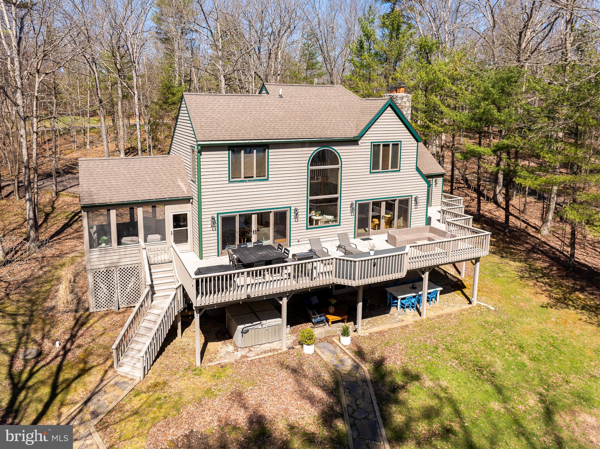 Welcome to 1038 S Blakeslee Road! A spacious lakefront retreat on Deep Creek Lake offering effortless lakeside living.  A Rare opportunity to own in one of Deep Creek’s most sought-after lakeside communities. This five-bedroom, five-bath home sits on a large 1.11-acre level lot with easy access to the water and generous outdoor space for recreation and entertaining. Inside, the home is warm and inviting with abundant natural light, beautiful hardwood floors, and stone fireplaces. The flexible floorplan provides multiple gathering spaces including the main floor living room and dining area opening to a screened porch and an expansive deck, seamless indoor/outdoor living within a serene lakeside setting. Practical details and timeless finishes combine for a relaxed yet refined lake-house feel. Enjoy exceptional community amenities including a large clubhouse with an indoor pool, pickleball and basketball courts, a soccer field and playground.  Do not miss this extraordinary chance to own this beautiful home in the Blakeslee!  Call today to schedule your private tour.