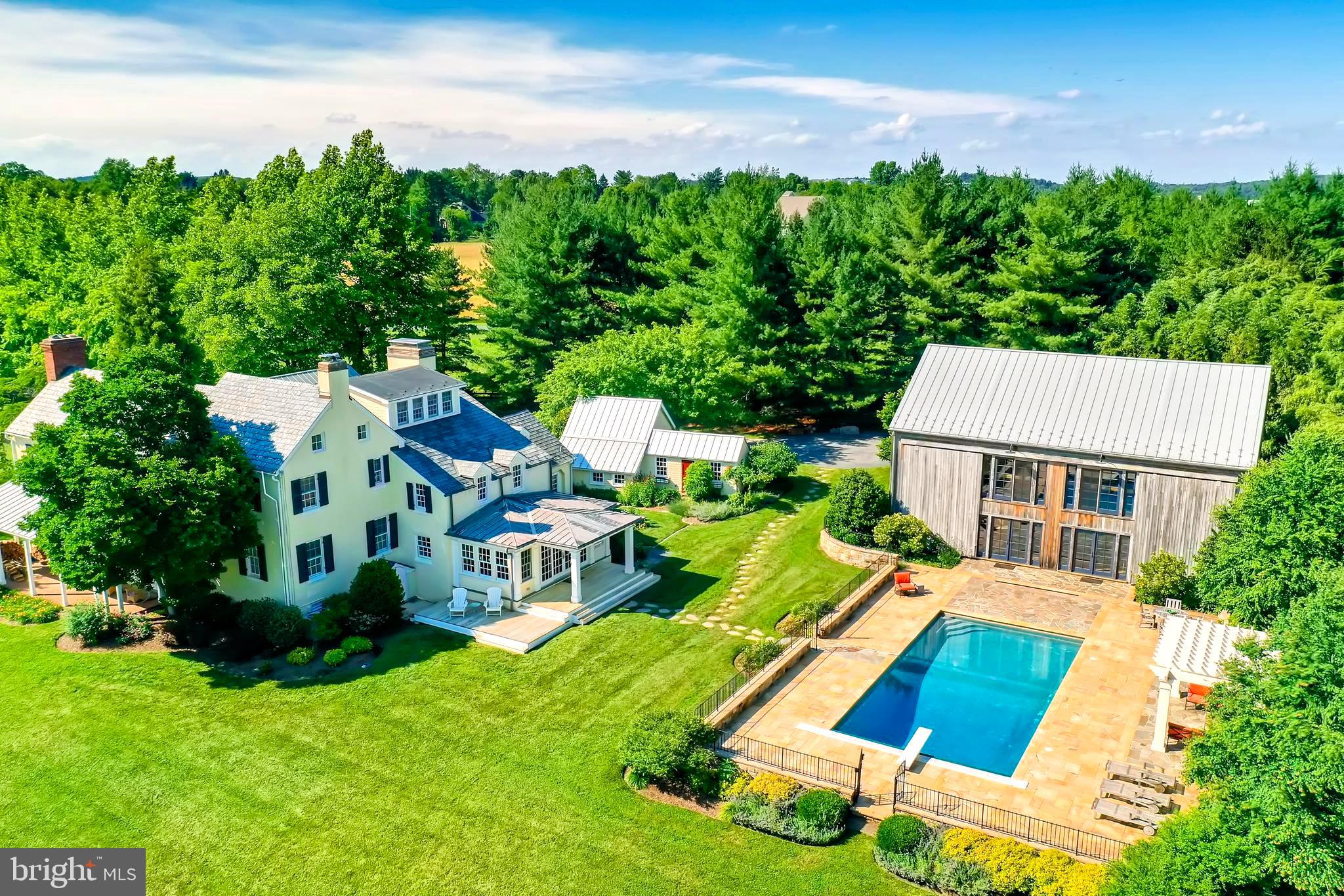 Bishop's Pond. Beautifully restored and updated circa 1800 estate on eleven private acres with magnificent 2300 sq.ft. 19th century hand-pegged New England barn. The converted barn rebuilt on site in 2005 is complete with geothermal HVAC, full bath and steam shower, a laundry, and a towering two-story entertainment space with expansive walls of windows overlooking a heated saltwater pool, formal border gardens, rolling green, and woodland vistas. The main residence, a 19th century stucco over stone farmhouse has been renovated and expanded featuring original heart pine floors, covered porches, elegant formal rooms, spacious bedrooms, and a two-story in-law suite with main level bedroom, laundry, and full bath. The light-filled gourmet kitchen offers stainless appliances, SubZero refrigerator, 6-burner Wolf cooktop, double ovens, and large breakfast/sunroom opens to charming kitchen gardens and springhouse. Opportunity abounds to enjoy native wildlife habitats from walking trails through lush meadows, wetlands, woodlands leading to ponds, and the glistening trout stream Beaverdam Run. Outdoor enthusiasts are drawn to the area known for steeplechase, horseback riding, biking, hiking, hunting, and fly-fishing. Conveniently located near Hunt Valley Mall and thriving business centers, scenic by-ways, farm stands, the renowned Oregon Ridge Park and Nature Center, and minutes to the Best of Baltimore on the harbor.