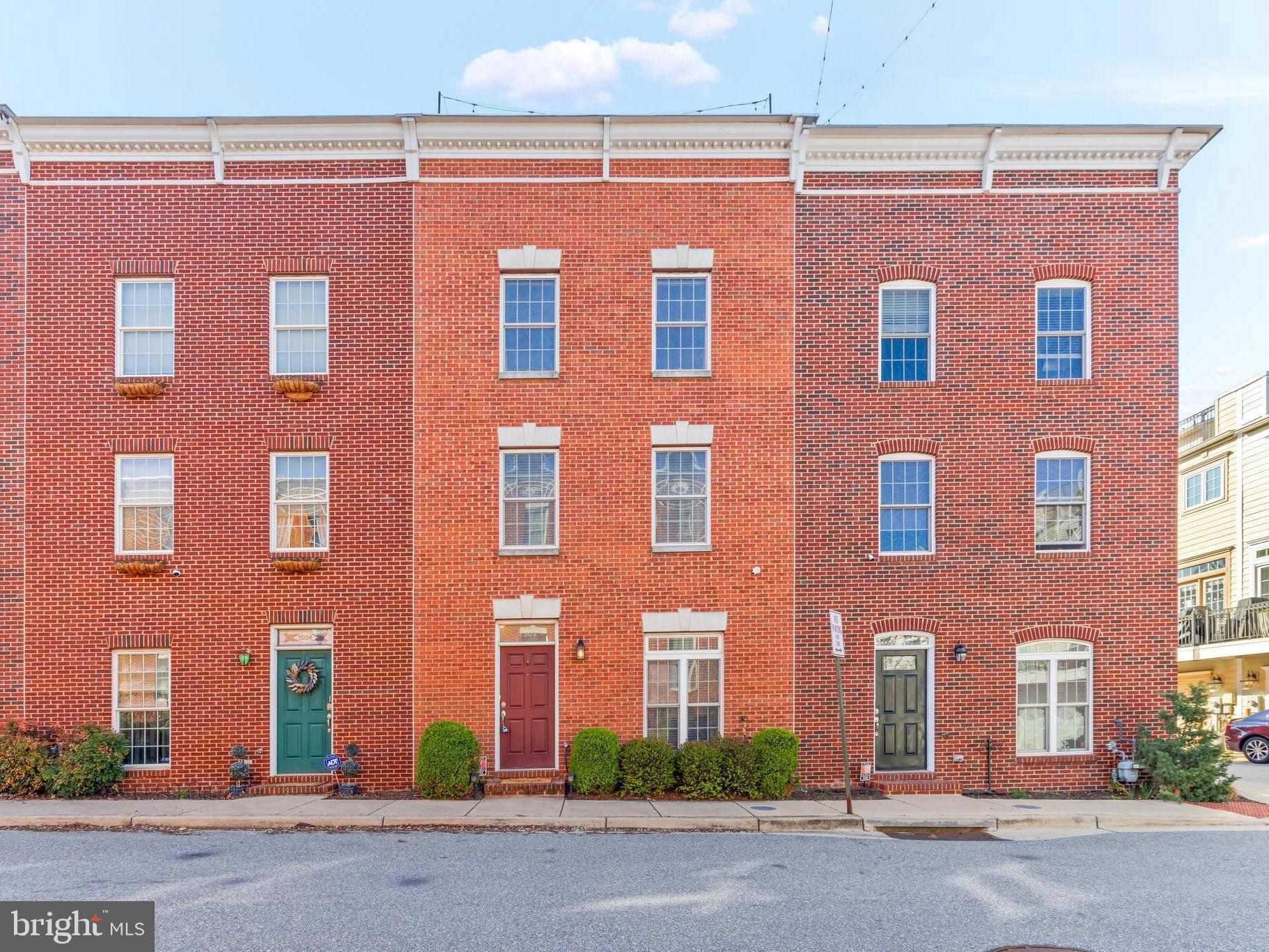 Welcome to 1502 Stack St, a newer home built in 2008, situated on a quiet, dead-end street in the heart of Federal Hill. Offering 4 levels of living space, this home features 3 bedrooms, 4 bathrooms, 3-car parking and a one-of-a-kind rooftop deck. Thoughtfully designed with modern touches, it perfectly balances style, comfort, and convenience. The first level has a versatile bedroom that could easily serve as an office or multi-purpose space, along with a half bathroom, laundry room, and access to the 2-car garage. The second level stands out with Brazilian Cherry Hardwood floors and an open-concept kitchen, complete with wood cabinetry, granite countertops, a tile backsplash, and stainless steel appliances, including a brand new microwave that doubles as an air fryer and convection oven. The large dining area offers access to a deck—ideal for outdoor meals and relaxation. The living room has amazing natural light and view of the neighborhood. On the third level, you’ll find 2 generously sized bedrooms, both with high-end carpeting, as well as 2 full bathrooms. The primary suite is equipped with a private bath and two walk-in closets for added convenience. A set of stairs leads to the fourth level, where you’ll find an award-winning rooftop deck featuring a Faux-grass floor for comfort, wet bar, and mini-fridge, offering the perfect space for entertaining and stunning views of the city and Harbor. Conveniently located within walking distance of bars, restaurants, parks, Merritt Gym, and more, this home combines urban convenience with comfort. Easily accessible to major commuter routes. Recent updates include HVAC condenser (2019), shutters & garage springs (2022), synthetic grass rooftop (2022), garbage disposal, backsplash, & paint (2023), ceiling fans (2024), and microwave (2025). Welcome home!