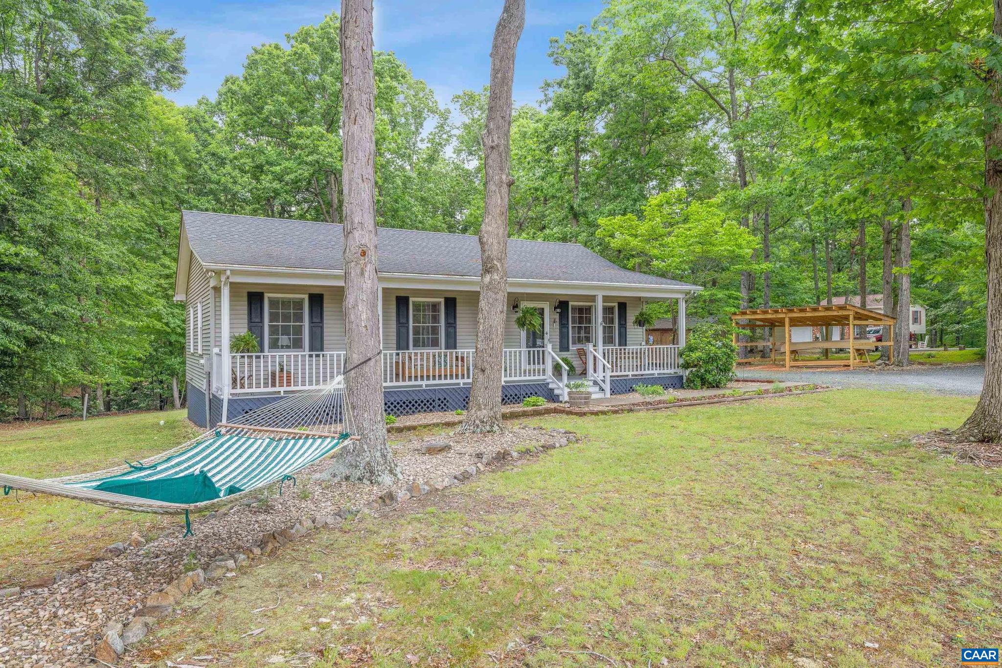 Escape the hustle and enjoy relaxed country living in this adorable, well maintained cottage nestled in the heart of Fluvanna County. Set on 2.26 mostly level acres, this three bedroom, two bathroom home offers the perfect blend of comfort, privacy and convenience.  Start your mornings with coffee on the back deck and unwind in the evenings on the welcoming covered front porch. Inside, you'll find a spacious living room, an inviting kitchen with breakfast nook, and three bedrooms off of the main hallway. The seller has taken the care to add a new vapor barrier to crawlspace, and build a "lean-to" shed for storage.  With no HOA, you have endless possibilities with this expansive property. An easy commute to Charlottesville, and minutes to Zions Crossroads, shopping, close to Ruritan Lake for outdoor recreation and local entertainment, you have the best of both worlds here! Make this your new home this summer! Shown by appointment.