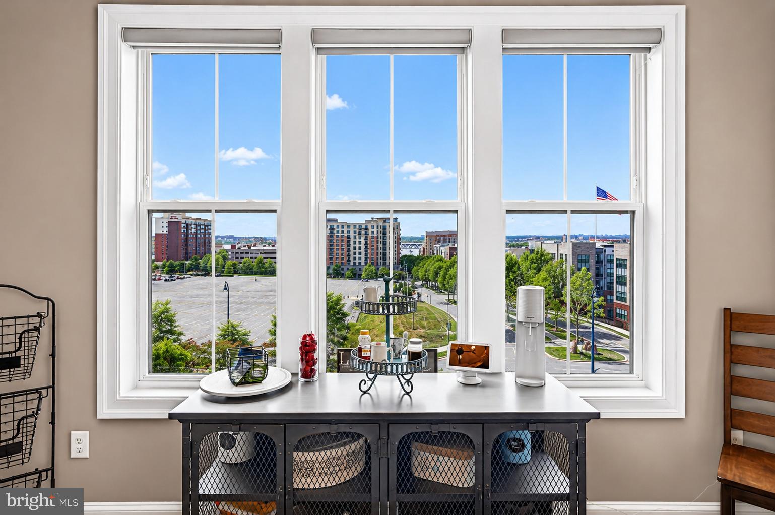 Exceptional lifestyle opportunity in the heart of National Harbor. Located in the gated Potomac Overlook community just minutes from the nation's capital, this rarely available end-unit townhome offers 4 bedrooms, 4.5 bathrooms, and over 3,600 finished square feet across four levels. Oversized windows on three sides flood the interior with natural light while showcasing spectacular views of the Potomac River from every level — including iconic vistas of the National Harbor Ferris Wheel, the Woodrow Wilson Bridge, and the Washington Monument in the distance. By evening, the backdrop transforms into shimmering city lights and seasonal fireworks.
The kitchen anchors the main living space with GE stainless steel appliances, a five-burner cooktop with 36" hood, double wall ovens, custom cabinetry with pull-outs, and a 13-foot quartz island built for everything from quiet mornings to large-scale hosting. Hardwood flooring runs throughout, complemented by designer tile in all bathrooms, elevated lighting, and detailed trim work.
Every bedroom is a private retreat with its own en-suite bath and Ronbow vanities — three with custom walk-in closets. A remote-controlled gas fireplace with LED lighting warms the second floor, and motorized blinds on the second and third levels add ease and elegance. The top-level loft is its own destination — a wet bar, wine fridge, integrated SONOS sound system that extends to the outdoor patio, and an indoor/outdoor fireplace that makes the space inviting year-round. 8-foot doors throughout and a two-car garage round out the thoughtful details.
Built in 2020 and meticulously maintained, with all major systems just five years young. Enjoy the vibrant lifestyle National Harbor offers — just moments from waterfront dining, boutique shopping, seasonal concerts and movie series, and exciting nights at MGM. The Potomac Overlook community itself features parks, gazebos, dog parks, and scenic walking and biking paths along the water. Homes like this — elevated finishes, flexible living, and unforgettable views — are rarely available.