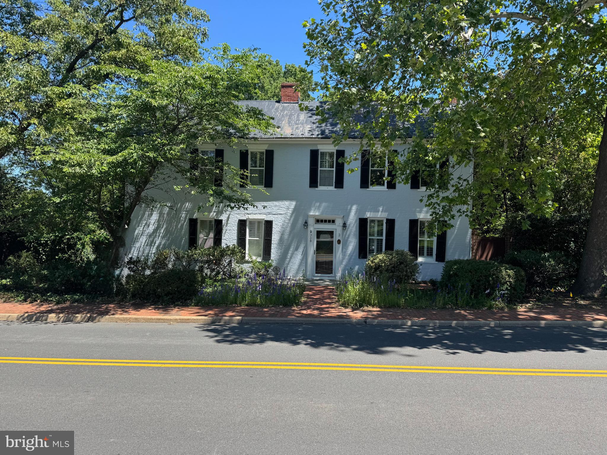 Welcome to 208 Edwards Ferry Road, where historic charm meets modern luxury, dating back to 1790. Situated on a private 0.73-acre lot, this thoughtfully updated 4-bedroom, 3-bath home features a fenced yard, mature trees, and professionally landscaped grounds.
The main level is designed for both comfortable living and effortless entertaining. A spacious, sun-filled family room features heated floors and electric blinds, opening seamlessly to an expansive patio complete with an electric awning, Big Green Egg grill, outdoor bar, and ample space for dining and gathering.
The chef's kitchen is equipped with updated appliances, including a convection oven, microwave, and a GE Café 6-burner gas stove-top with a dedicated wok burner. Heated ceramic floors and a filtered-water system add comfort and convenience.
A main-level bedroom is currently configured as a pantry and laundry room, but can easily be converted back to a bedroom if desired. The formal dining room, featuring one of the home's five working fireplaces (four wood-burning and one gas), provides a warm and inviting setting for entertaining. A separate entrance from the driveway offers an elegant way to welcome guests. Just off the dining room, the parlor/game room provides the perfect space to relax and unwind.
Upstairs, you'll find three generously sized bedrooms and two full baths, including a spacious primary suite with heated bathroom floors. A walk-up attic offers abundant additional storage space.
Major systems have been updated, including two HVAC units that are less than five years old and one of the two recently replaced hot water heaters.
Wine enthusiasts will especially appreciate the custom wine cellar, featuring built-in racks with capacity for up to 900 bottles, accent lighting, and a dedicated new cooling system to maintain ideal storage conditions. In addition, a second cellar provides extensive storage space.
Outside, you'll find a shed, a workshop, and a greenhouse. **Driveway gate and windows are AS-IS**
Combining timeless character with modern upgrades, exceptional outdoor living, and unique amenities, this one-of-a-kind property offers a rare opportunity to enjoy both historic elegance and contemporary comfort.
Walk to over 70 shops, restaurants, and year-round community events. From the beloved Flower & Garden Show and Antique Car Show to vibrant art festivals, Halloween celebrations, and the iconic 4th of July parade, there’s always something to experience just moments from your doorstep. Steeped in rich history, Loudoun County lies at the heart of Virginia’s renowned Hunt and Wine Country. Ideally located just 15 minutes from Dulles International Airport and within easy reach of Washington, D.C., the area offers both convenience and charm. Nestled at the base of Catoctin Mountain and along the Potomac River, Leesburg is a picturesque historic town and the county seat of Loudoun County. The region is known for its exceptional schools, historic landmarks, destination dining, and vibrant lifestyle. From steeplechase racing and twilight polo matches to award-winning wineries, seasonal festivals, and country fairs, it’s easy to see why Loudoun County is consistently ranked among the best places to live in America.