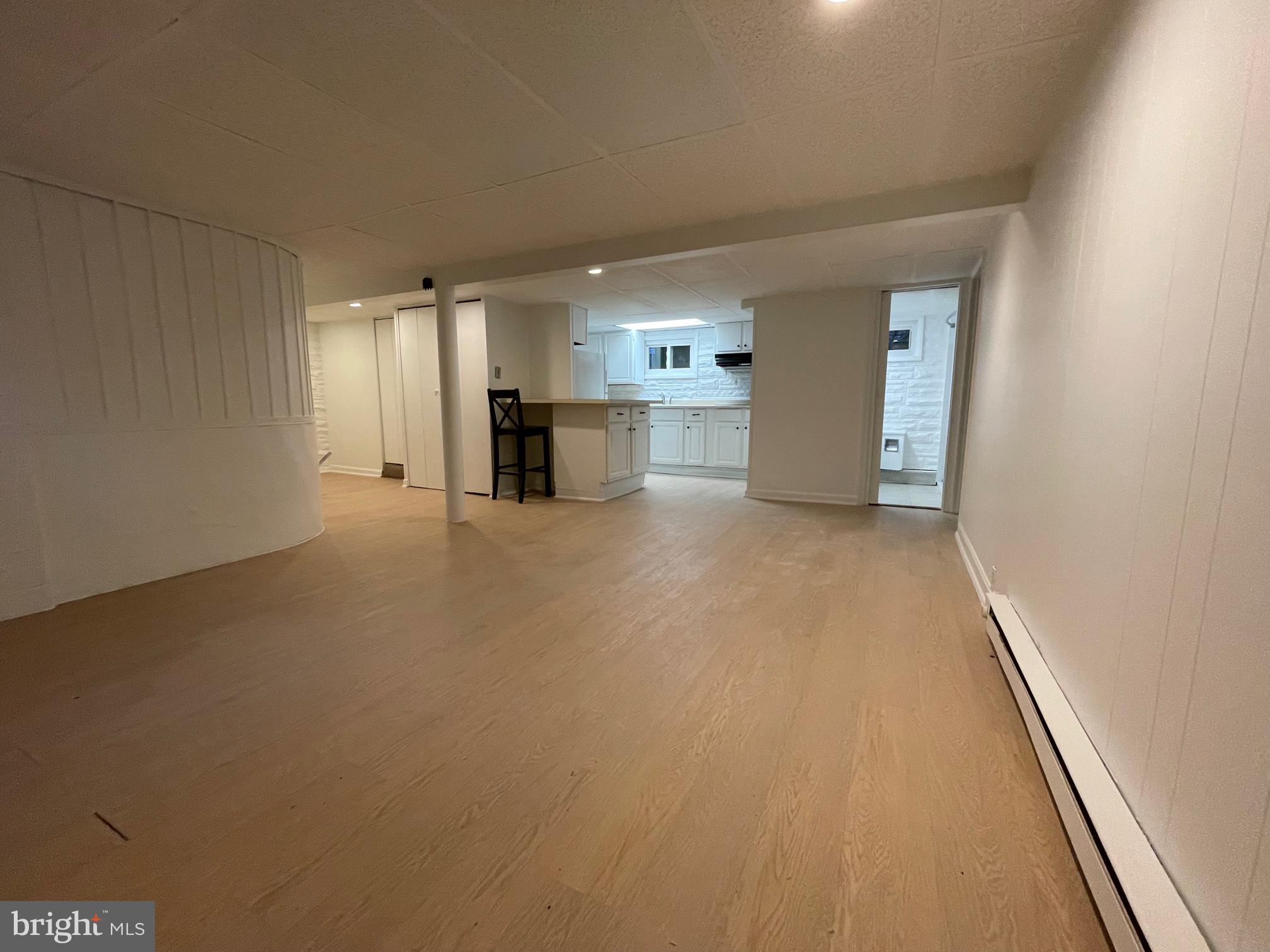 Basement apartment in 3 unit house.  Available NOW.  Freshly painted, new carpeting, recent LVT flooring, direct access to shared laundry room (free).  Utilities included.  One bedroom and open office/den, 2 walk-in closets.  Building has new water heater.  One parking space included.  Walk to bus stop, new Purple Line is a short distance away.  Owner/Agent.  Tenant pays for credit check $47. per adult.  No smoking or vaping, No Pets.