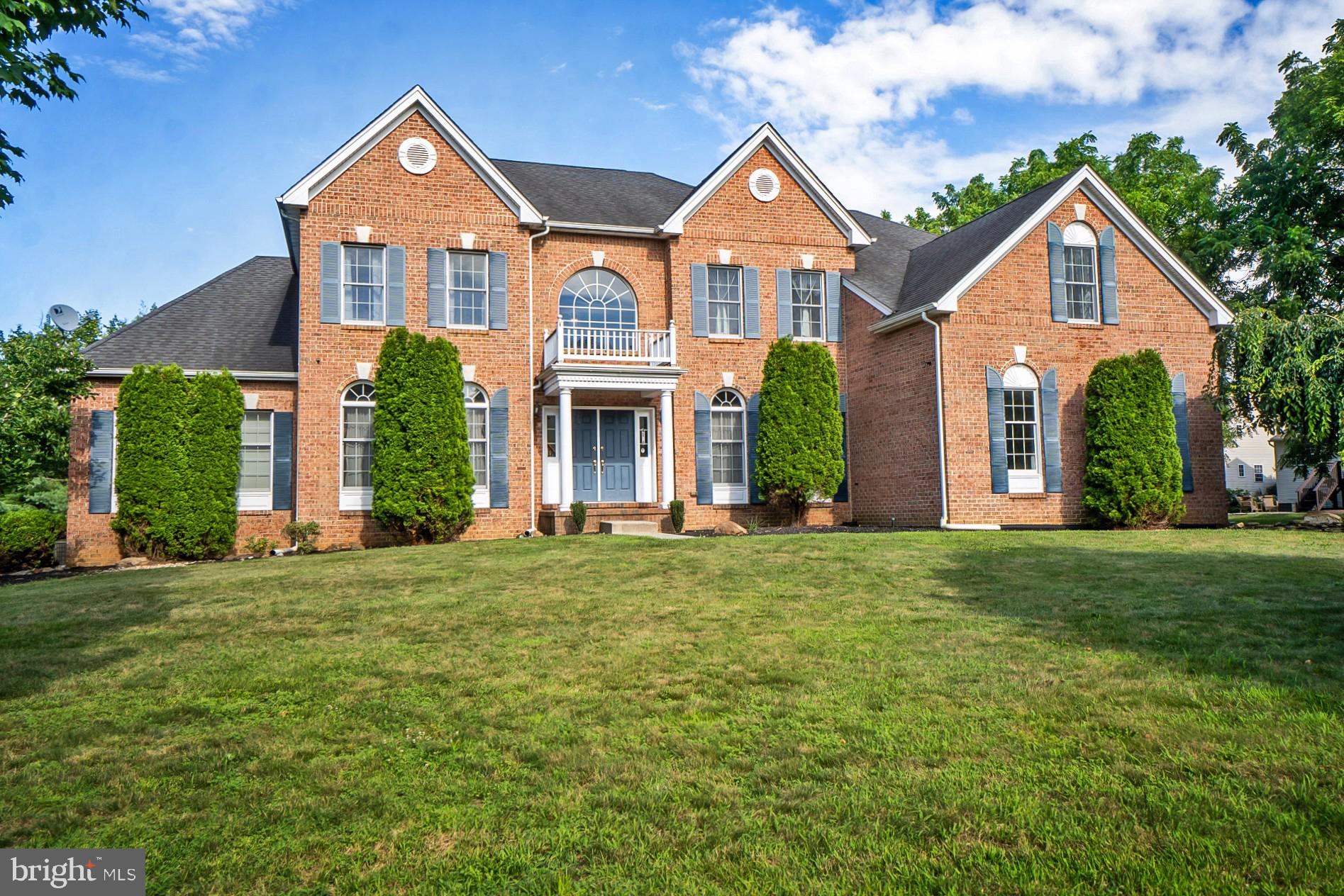 Gracefully set in the sought-after Bethlehem Estates, this stately brick Colonial blends timeless elegance with modern flexibility. It offers over 4,600 sq ft of finished living space, plus a 3,195 sq ft unfinished walkout basement with double French doors...ideal for future expansion. With 5 bdrms & 4.5 ba., the layout adapts beautifully to evolving needs...whether working from home, hosting guests, or enjoying the luxury of space. A full guest wing on the main level includes a sitting room, bedroom, walk-in closet, & full bath...great for multigenerational living. A sweeping staircase opens to a dramatic two-story foyer with hardwood floors throughout the main level. Formal living and dining rooms feature crown molding and tray ceilings. The kitchen includes granite counters, center island & stainless appliances. It opens to a sunny breakfast area & an exceptionally large sunroom with patio access. The family room features 19.5’ ceilings, arched windows, & a brick fireplace. Upstairs, the primary suite includes a sitting area, spacious walk-in closet, and spa bath with walk in shower. One upstairs bdrm is a princess suite with full bath, while bedrooms 3 & 4 are joined by a split-entry bath. A private, tree-lined backyard with a paver patio & 3 car garage...without HOA restrictions. Located in Bethlehem SD near major commuting routes, trails, shopping, schools, and hospitals. Clear certificate of Occupancy on file from Bethlehem township.