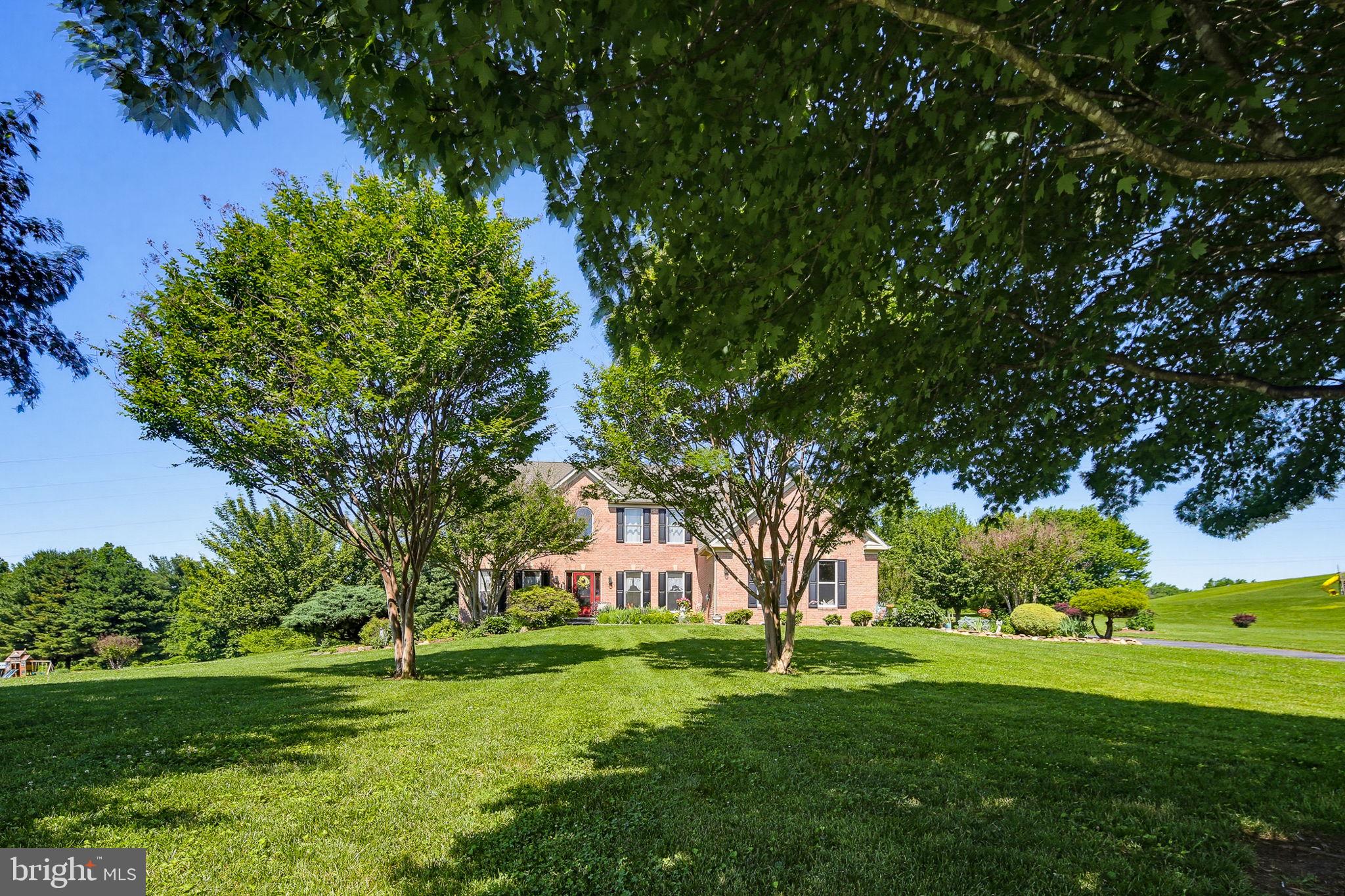 Welcome to 3211 Granite Road, Woodstock, MD — an exceptional estate property set on beautifully manicured grounds, offering the perfect blend of elegance, comfort, and privacy. From the moment you arrive, the impressive curb appeal, mature landscaping, and expansive homesite create a grand first impression that continues throughout the home.

Step inside to a soaring two-story foyer flanked by formal living and dining rooms, creating sophisticated spaces for entertaining and special occasions. The heart of the home is the spacious gourmet kitchen, featuring granite countertops, abundant cabinetry, a center island, and a bright breakfast area surrounded by windows overlooking the backyard. The kitchen flows seamlessly into the dramatic family room with soaring ceilings, a striking floor-to-ceiling stone fireplace, and walls of windows that fill the space with natural light.

A sun-filled morning room provides the perfect place to enjoy coffee while taking in views of the surrounding landscape. The main level also offers a private office, ideal for working from home, along with thoughtfully designed living spaces that balance everyday functionality with refined style.

Upstairs, the luxurious primary suite serves as a private retreat, featuring a spacious sitting area, tray ceiling, oversized walk-in closets, and a spa-inspired bath complete with dual vanities, a soaking tub, and a separate shower. Three additional generously sized bedrooms offer comfortable accommodations for family and guests, each with ample closet space and abundant natural light. A spacious hall bath with a double-sink vanity provides convenience for busy households while offering plenty of room for daily routines.

The fully finished lower level expands the home's living space with an expansive recreation room, multiple gathering areas, a full bath, and additional finished rooms perfect for a home gym, media room, hobby space, or guest accommodations.

Outside, the backyard is a true private oasis. A large paver patio offers ample space for outdoor dining and entertaining, while the sprawling lawn, mature trees, and professionally landscaped grounds create a peaceful setting rarely found. Whether hosting gatherings or enjoying quiet evenings under the stars, this outdoor space is designed to impress.

Conveniently located in sought-after Woodstock, residents enjoy easy access to nearby shopping and dining at the nearby shopping centers along Route 40 and Route 29, as well as outdoor recreation at nearby parks and trails, including Patapsco Valley State Park. Commuters will appreciate convenient access to major routes connecting Baltimore, Columbia, Ellicott City, and Washington, D.C.

This distinguished estate offers the space, setting, and timeless appeal that luxury buyers seek—an exceptional opportunity to own a remarkable home in one of Howard County's most desirable locations.
