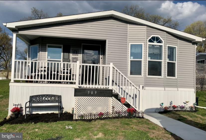 Better than new!  So many upgrades have been added in this beautiful, spacious one floor living you will love to call "my new home".   Upgrades include new lighting in both bathrooms , tile backsplash in the kitchen, shiplap in the main bath,  a walk in tile shower in master bath, ceiling fans,  a screen door, a new 8 x 10 shed with motion sensor lights plus a warranty will be  transferred through the end of January. All three bedrooms have large closets, the laundry room has its on side entrance, the kitchen is bright, roomy and the appliances are less than a year old. The living room is so large half of it became an entertainment area. You have a parking pad for 2 cars, a lovely front porch, plus the lot rent includes the water, sewer and trash.   The back yard area is private and the location is  minutes to Rte 61. This home is a must see, is move in ready . Set up your showing today.