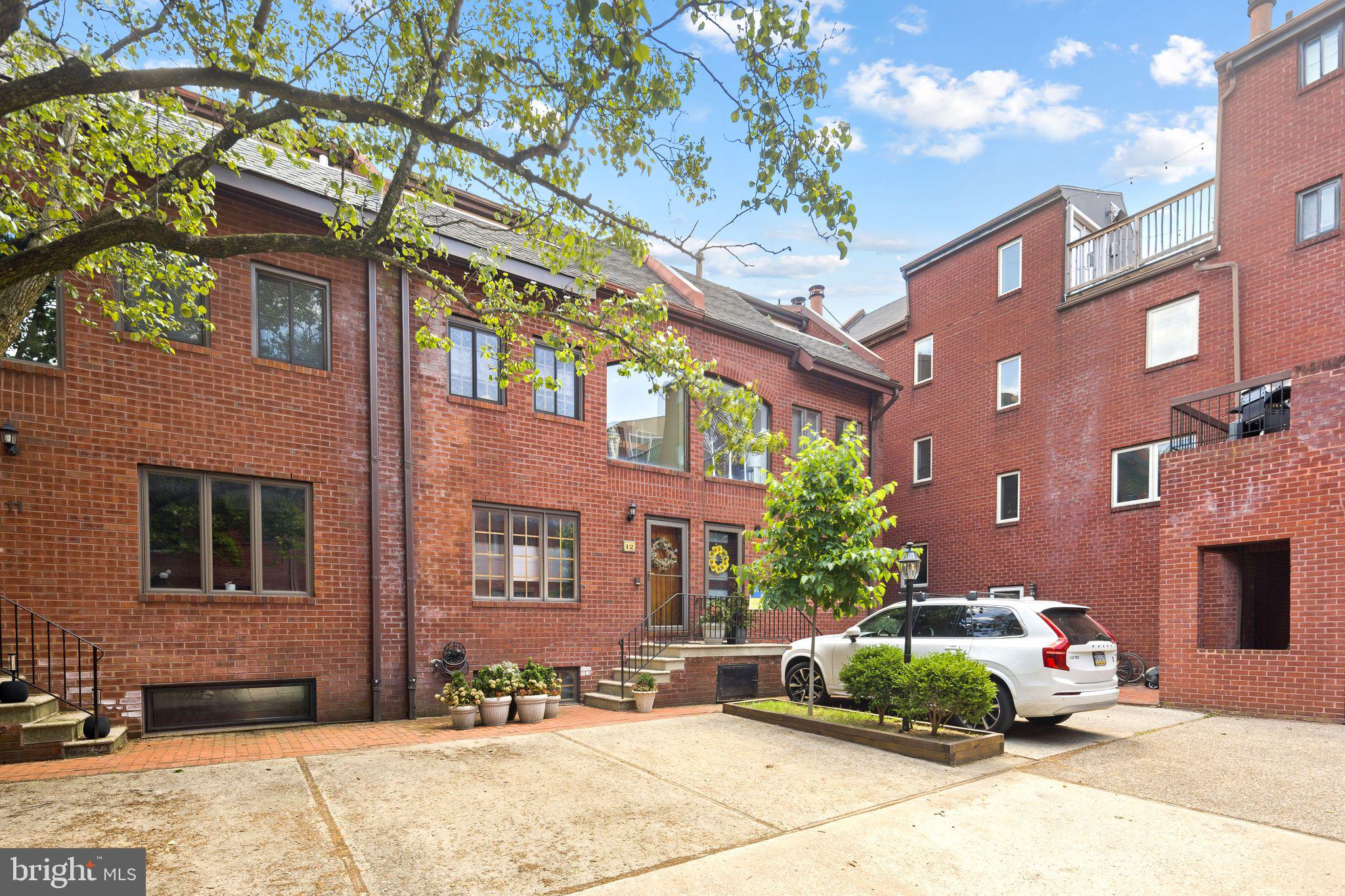 Tucked into a peaceful courtyard in prime Queen Village, this 3 bedroom, 2.5- bath home offers one-car on-site parking and access to the highly regarded Meredeth School District. Situated within a rare, gated community, the home features a shared private courtyard with a dedicated parking space directly in front of the property.  Enjoy the charm of a quiet residential setting while being steps from markets, shopping, dining, and more.
Enter into a bright, sun-filled eat-in kitchen, perfect for everyday living.  Entertain effortlessly in the elegant dining room complete with custom built-in cabinetry, unwind in the sunken living room featuring soaring ceilings, recessed and gallery lighting, and a cozy wood burning fireplace.  Step outside to the private patio, ideal for grilling or enjoying your morning coffee.
Just below the living room is a versatile den with a convenient half bath, perfect for a home office, media room, or guest space, along with access to the full laundry and utility room.
The second floor offers two spacious bedrooms and a full bath, ascend to the third floor where a dramatic picture window floods the space with natural light, leading to the primary suite.  This retreat features loft-style ceilings, a private balcony with skyline views, and a full bath.  In addition to central air, the primary bedroom has been upgraded with a dedicated mini-split system for enhanced comfort.
This exceptional home combines privacy, character, and city convenience in one of Philadelphia's most desirable neighborhoods.