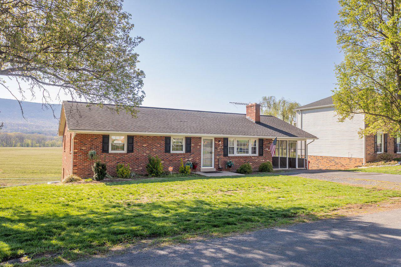 NEW PRICE – Priced to Sell! Welcome home to the cozy town of Mount Jackson, where small-town charm meets beautiful Shenandoah Valley scenery. This well-maintained all-brick rancher offers 3 bedrooms and 2.5 bathrooms, with thoughtful updates and inviting spaces designed for comfortable everyday living. If you're looking for main level living with additional space to bring your own creativity and finishes, this is the home for you. 

Inside, you’ll find updated flooring, a beautifully refreshed kitchen, and spacious living and dining areas that feel warm and welcoming. The inviting screened-in porch is the perfect place to relax with your morning coffee or unwind in the evening while soaking in the fresh country air and taking in the peaceful mountain views.

The walkout basement provides exceptional flexibility and space to make your own, featuring a large laundry area, abundant storage, and plenty of room for a home gym, workshop, or hobby space. From the back porch and rear rooms of the home, enjoy breathtaking mountain views that create a serene backdrop year-round.

Solidly built, lovingly cared for, and ideally located in the heart of Mount Jackson, this charming home offers the perfect blend of comfort, space to grow, and Shenandoah Valley beauty.