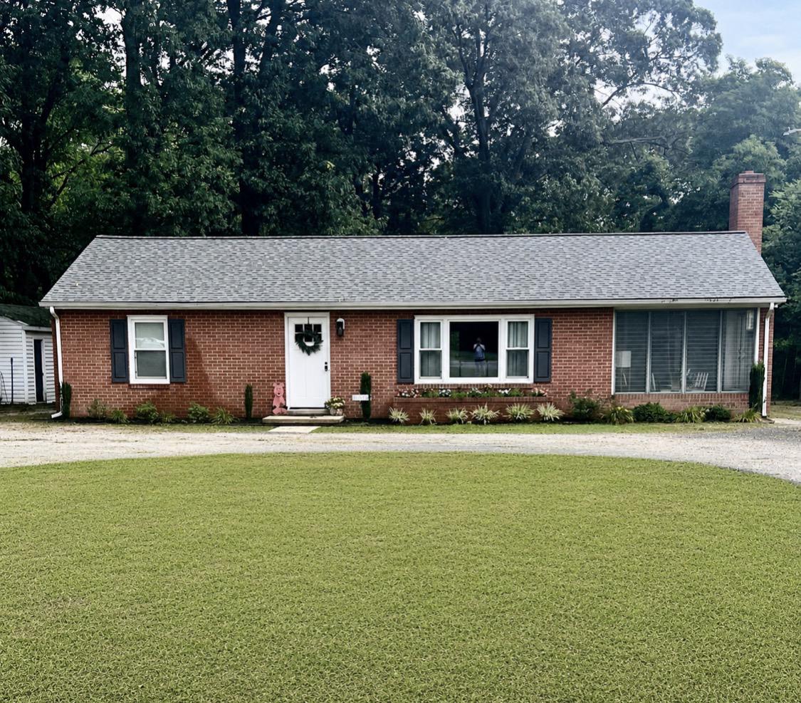 Discover the charm of this beautifully maintained ranch-style home, a perfect blend of comfort and functionality. Nestled on a generous 0.68-acre lot, this property offers a serene retreat while being conveniently located for easy access to everyday amenities. Step inside to find an inviting open floor plan that seamlessly connects the living and kitchen areas, ideal for both entertaining and everyday living. The spacious living room is enhanced by recessed lighting and a ceiling fan, creating a warm and welcoming atmosphere. Equipped with modern appliances, including a refrigerator, stove, dishwasher, and icemaker, this kitchen is designed for culinary enthusiasts and casual cooks alike. This home features two well-appointed entry level bedrooms, that offers convenience and accessibility. The primary suite is complete with an en-suite bathroom that ensures privacy and comfort. Both bathrooms are thoughtfully designed, showcasing modern fixtures and finishes that elevate your daily routine. The interior is adorned with luxury vinyl plank flooring, providing durability throughout. With only one level and separate area, laundry chores become a breeze, allowing you to spend more time enjoying your new home. Outside, the property features an outbuilding, perfect for additional storage or as a workshop for your hobbies. The circular driveway not only enhances curb appeal but also provides ample parking for guests. Imagine hosting summer barbecues or simply enjoying the tranquility of your expansive yard, where the possibilities for outdoor activities are endless. This home is not just a place to live; it's a lifestyle choice. With the central county location, excellent condition and thoughtful design, it's ready for you to move in and make it your own. Schedule your private tour today and envision the memories waiting to be made in this lovely home!