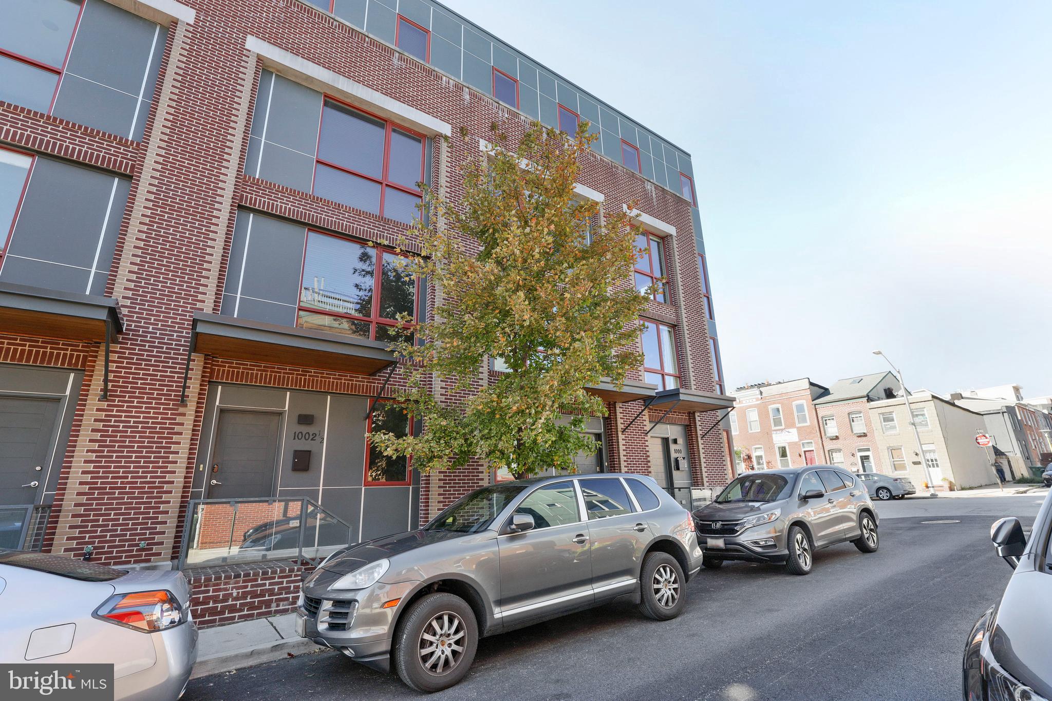 WELCOME TO A METICULOUSLY MAINTAINED MODERN ROW HOME IN THE HEART OF CANTON.  NO DETAIL WAS OVERLOOKED IN 1002 S DECKER.  THE FIRST FLOOR FEATURES A NICE SIZED BEDROOM, COMMONLY USED AS AN OFFICE OR FLEX SPACE (GYM IN PICTURES), PLUS AN ENORMOUS 2 CAR GARAGE WITH TALL CEILINGS AND ACCESS TO DUMB WAITER WHICH GOES TO ALL 4 FLOORS.   THE SECOND LEVEL FEATURES THE PRIMARY BEDROOM & BATHROOM, LAUNDRY, AND AN ADDITIONAL GUEST SUITE & FULL BATH.   THE PRIMARY BEDROOM IS BEAUTIFUL WITH CUSTOM WARDROBE, WALK IN CLOSET, AND A LUXURY BATHROOM WITH HEATED FLOORS, QUARTZ TOPS, CUSTOM LIGHTING, AND HUGE GLASS SHOWER WITH BODY JETS.    THE THIRD LEVEL IS THE MAIN LIVING AREA WITH KITCHEN, DINING, AND FAMILY ROOM.  ENJOY INCREDIBLE VIEWS OF DOWNTOWN FROM YOUR KITCHEN!  THIS IS TRULY A CHEF'S KITCHEN WITH AMPLE COUNTERTOP AND CABINET SPACE WITH A SLEEK SCANDINAVIAN DESIGN.   THE THIRD FLOOR FEATURES CUSTOM BLINDS AND A POWDER ROOM AS WELL.  THE FOURTH FLOOR BOASTS AN ADDITIONAL LIVING SPACE WITH WET BAR THAT LEADS OUT TO A TWO-TIER ROOFTOP DECK WITH INCREDIBLE VIEWS.  ALSO ON THE 4TH FLOOR IS A 4TH BEDROOM SUITE WITH ITS OWN FULL BATHROOM, 2 WALK IN CLOSETS, AND TONS OF NATURAL LIGHT.    THIS IS A SHOWCASE PROPERTY UNDER 800K!  LOCATION, DESIGN, & FINISHES ARE SECOND TO NONE AT 1002 S DECKER!
