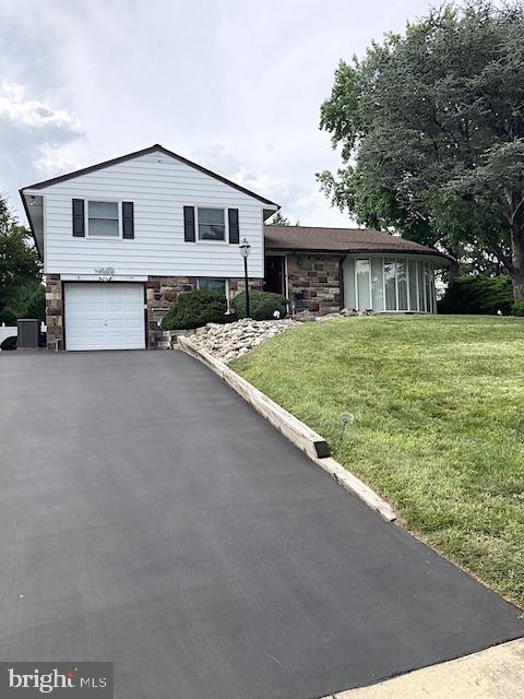 Split-level home • Huntingdon Valley • Remodeled kitchen 2016 • Gas fireplace • Pella windows • Lennox HVAC 2021 • Private patios • Walk-up attic • 0.4 mi to Lormer Park •  Shopping: 0.8 miles • Hospitals 1.2 miles • Regional rail: 1.4 miles

This beautiful corner property is located on a quiet street in the sought after June Meadows neighborhood. Welcome to 1180 Ballytore Road a well-maintained split-level home offering 3 bedrooms, 2 ½ baths with garage and thoughtful updates throughout. The living room features a dramatic floor-to-ceiling bow window and a vent-free gas fireplace added in 2015, while the formal dining room enjoys garden views through an oversized window.
The kitchen was fully rebuilt to the studs in 2016 and includes 42-inch custom cabinetry, a granite peninsula, Pergo flooring, recessed lighting, and a Pella sliding glass door opening to the Private rear patio opening to a private rear patio surrounded by mature landscaping. Steps connect to a lower patio off the family room, creating an easy indoor-outdoor flow.
Upstairs, the primary bedroom offers dual closets and a private bath, joined by two additional bedrooms with ceiling fans, newer doors, and custom built-ins for storage or workspace. A full hall bath with vanity and tub serves the additional bedrooms. Hardwood floors are present beneath carpeting on the first and second levels. A walk-up attic provides convenient storage or future flexibility.
The lower level adds versatile living space with a family room, updated powder room, exterior access to the backyard, and a carpeted utility area with washer and dryer(2021), leading directly to the attached garage.
Notable upgrades include Pella windows in 2016, a Lennox gas HVAC system in 2021, a roof with custom gutters and downspouts in 2017 with a 30-year warranty, a 200-amp electric panel replaced in 2015, a 40-gallon hot water heater in 2020, driveway excavation in 2016, Pulse custom alarm system in 2016, automatic outdoor sprinkler system, and an outdoor storage shed.
Conveniently positioned approximately 0.4 miles from Lormer Park, 0.8 miles from shopping, 1.2 miles from hospitals, and 1.4 miles from regional rail, this home combines thoughtful updates with a practical layout in a desirable Huntingdon Valley setting.