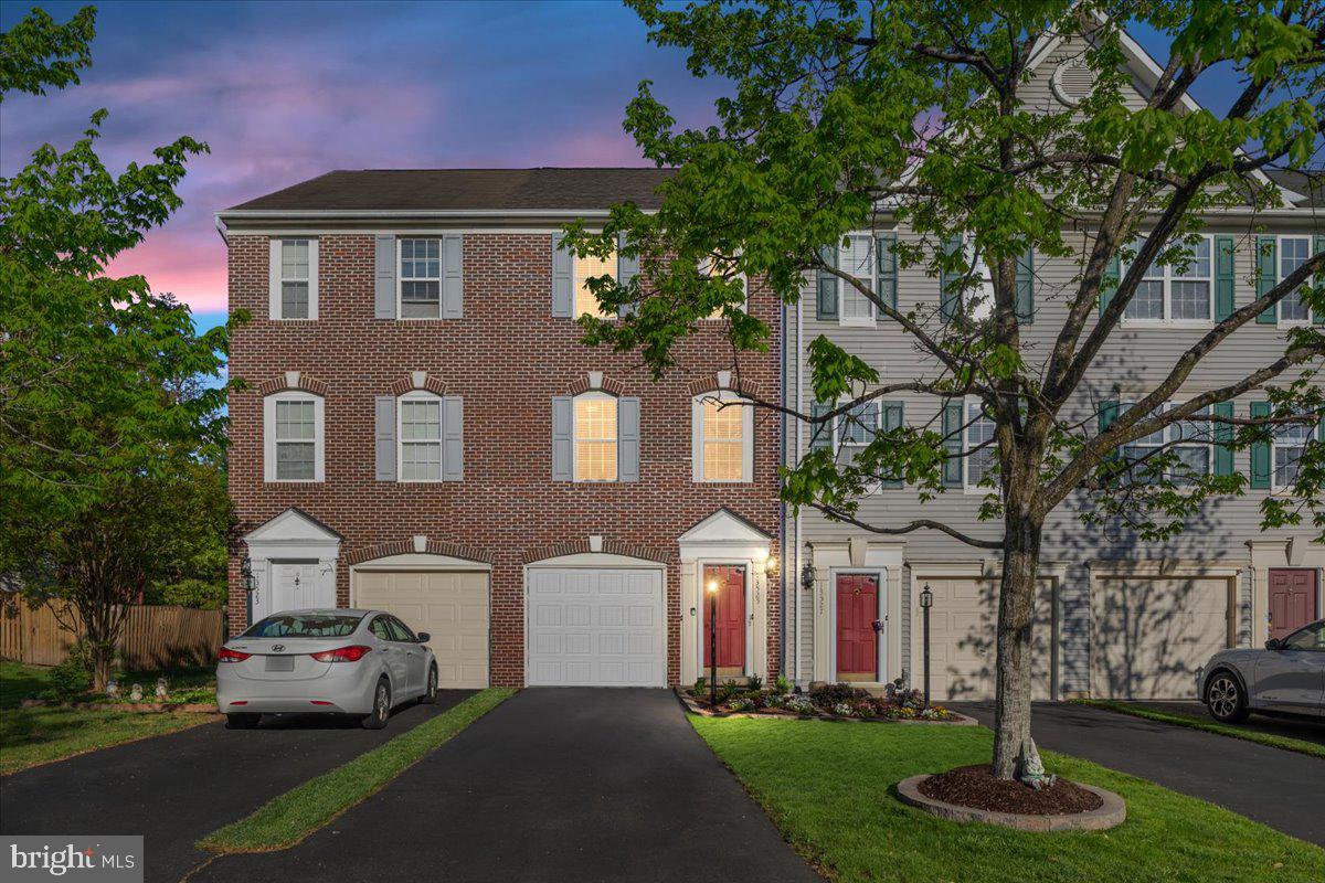 Now Active in Kingsbrooke! This tidy 3-level brick-front townhome offers just the right amount of space in a location that makes life easy. The kitchen is designed for convenience, with quartz countertops, stainless steel appliances, and a recently added built-in microwave — all in excellent condition. Light-filled living and dining areas open to a private deck, while the lower level features a finished walk-out basement that steps onto a patio inside a fully fenced yard — perfect for enjoying a little fresh air or quiet privacy. Upstairs, the primary bedroom includes vaulted ceilings, a private bath, and great closet space. The attached garage provides both parking and bonus storage. Neighborhood amenities include a pool, tennis courts, trails, and playgrounds — and with shops, dining, and major commuter routes just minutes away, this one is all about smart, convenient living.