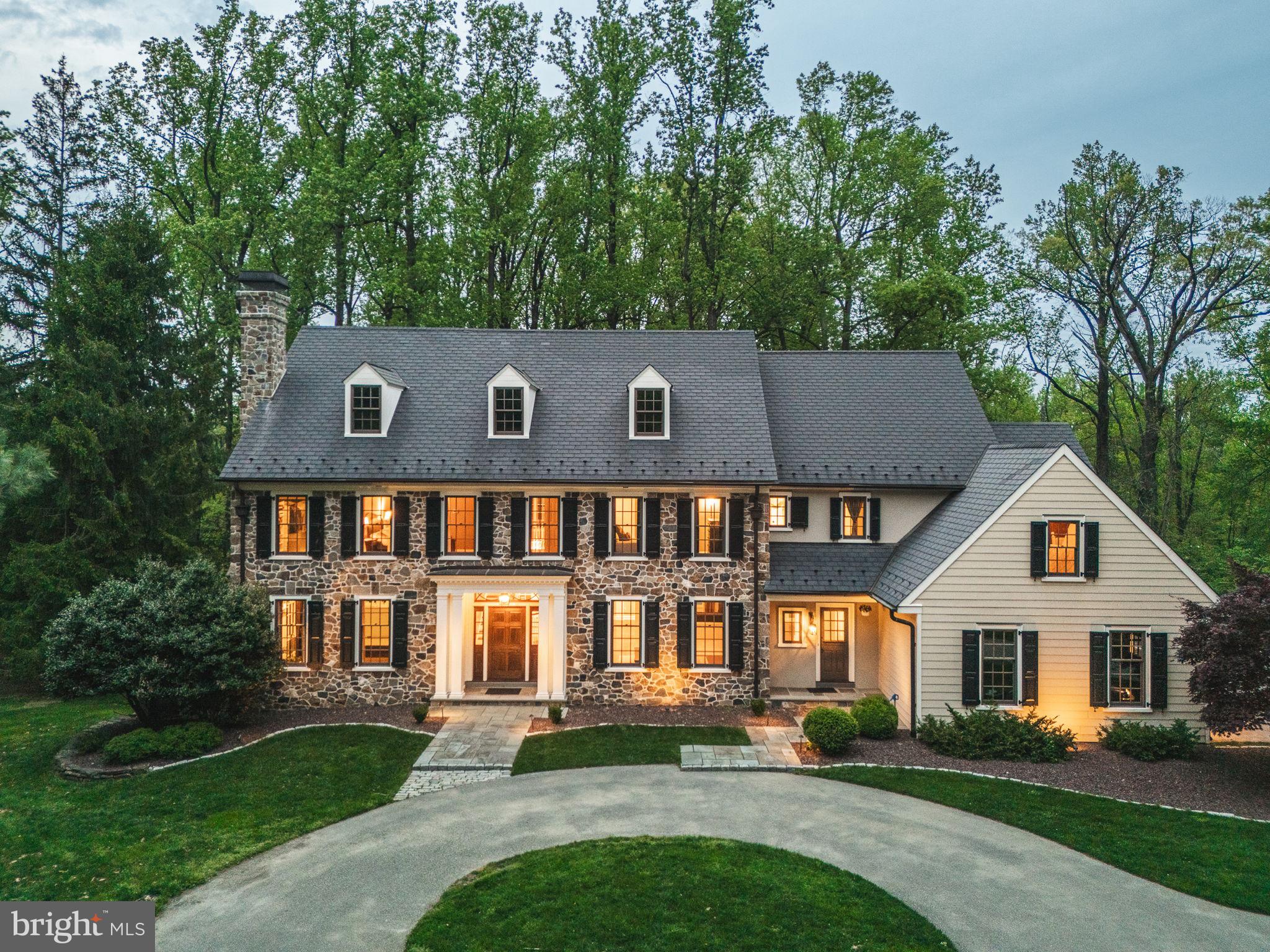 Nestled on a picturesque 3-acre lot in the rolling hills of Malvern, 4104 Howell Road is an exceptional custom residence that artfully blends timeless Chester County charm with cutting-edge design and modern comfort. Painstakingly reimagined through a million-dollar, multi-year renovation—featured in Philadelphia Design Guide—this home is a rare find in the sought-after Great Valley School District, offering privacy and tranquility just minutes from Wegmans, the Rte 29 Turnpike EZ Pass ramp, and everyday conveniences.

From the moment you arrive, the attention to detail is unmistakable. The exterior has been professionally refaced with hand-laid, 2-inch thick cut stone and upgraded to resemble a mid-century Chester County farmhouse. A custom-built entryway welcomes you with a 2 ¼” thick mahogany door, flanked by matching sidelights and crowned by an artisan-crafted entablature from Historic Doors of Kempton. The 50-year EcoStar synthetic slate roof with copper valleys, snow cleats, and hand-crafted chimney cap ensures low-maintenance longevity. Pella Architect Series windows with Timberland Endurian shutters, a copper gutter system with leaf shields, and period-matching upgraded exterior lighting further elevate the home's curb appeal. The front yard has been thoughtfully opened up and framed by a perimeter stone wall, while bluestone and flagstone walkways, stone stairs, and professionally designed landscaping create multiple inviting outdoor living spaces—including TimberTech decks with stainless steel railings and custom stone walls.

Inside, refined elegance meets functional design. The open foyer with a custom floating staircase—crafted with a concrete stringer and reclaimed wood treads—sets the tone for the exceptional craftsmanship found throughout the home. The main level features formal living and dining rooms, a private office, a butler’s pantry, mudroom, two powder rooms, a gourmet kitchen equipped with Viking, Meile, and GE monogram appliances and a sun-filled breakfast area along with a great room with a gas fireplace.

The upper level boasts five generously sized bedrooms, 4 with direct bathroom access.  The luxurious primary suite is complete with a spacious dressing room, walk-in closet, and spa-like bath. 

Descend the floating staircase to the walkout lower level—a showstopper designed for both intimate gatherings and grand entertaining. Here you’ll find a floating glass bar imported from ThinkGlass Quebec with dimmable and color selectable LED lighting, floating shelves made from reclaimed Chester County barn wood, a wine cellar that stores up to 1,800 bottles on an imported stainless steel rack system, leathered granite countertops, a commercial-grade Scotsman ice maker, touch-activated faucet, GE Monogram refrigerator with convertible drawer, built in dishwasher, a remote-controlled ribbon fireplace set against floor-to-ceiling Italian marble. Ten individually dimmable lighting zones, a curved bathroom wall and door, media area, and recreation space round out this truly remarkable level.

Additional highlights include a four-zone Bryant Evolution HVAC system with propane backup (installed 2015 and 2017), Generac 20kW whole-house generator, Rheem 75-gallon water heater, Azek exterior trim and crown molding, FX Luminaire six-zone landscape lighting, red stone garden beds with weed barriers, and comprehensive SMART home integration—including HVAC, interior/exterior lighting, Nest Protect CO/smoke detectors, landscape lighting, alarm system with cellular monitoring and water sensors, and a 7-zone Sonos system throughout the main level and basement.

This extraordinary property delivers the ultimate in sophistication, technology, and comfort—offering a truly unmatched lifestyle experience in one of Malvern’s most desirable locations.