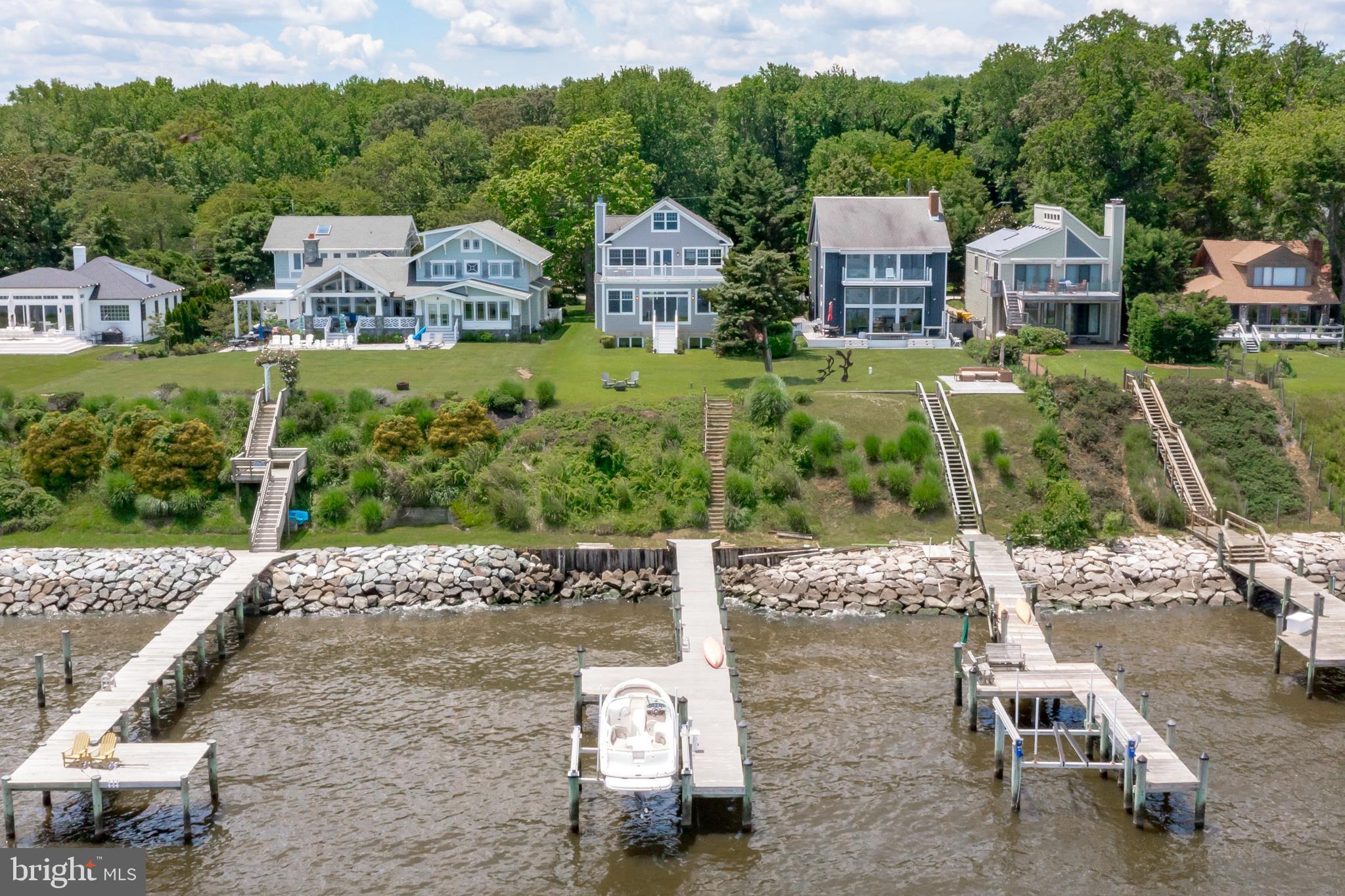 Breathtaking views abound from this stunning bay front home on the Chesapeake Bay!  Unwind and relax and enjoy the cool Bay breeze while you watch the ships go by!  Enjoy breathtaking sunrises and picturesque views of the Baltimore Lighthouse and Gibson Island-you can see for miles and miles!  Custom built in 2002, this 5 bedroom, 3.5 bath home is located in the community of Tydings on the Bay/Podickory Point on a quiet no thru street.  This fabulous home offers everything you need to enjoy the waterfront lifestyle. The light-filled and spacious open floor plan allows views from every room.  A large kitchen with granite countertops opens to the dining room with a charming window seat, and the spacious living room, featuring a wood burning fireplace and built in bookshelves.  A  first floor office (or additional bedroom), a large laundry/mudroom,  and half bath finish off the main floor. On the upper level you will enjoy more breathtaking views from the primary bedroom and bath.  Enjoy the views and spectacular sunrises from the balcony/deck just off the primary bedroom. There are  3 additional  large bedrooms on the upper level with a shared bathroom.  The lower level boasts an additional family room, full bath and a bedroom.  A two car garage and workshop provide plenty of space to store your water toys and cars.   The expansive yard is perched above the Bay and  is a great place to entertain friends and family.  No flood insurance needed.  Head on down to your very own private dock with lift and take the boat for a ride on the bay, the nearby Magothy River or head over to downtown Annapolis. The house is just down the street from the Podickory Point Yacht and Beach Club where membership provides access to the pool, beach, deep water marina and bar. This property is located in the Broadneck school district and it is the perfect location for quick access to hiking in Sandy Point State Park, heading over the Bay Bridge to the Eastern shore or jumping on Rt. 50 to Washington, DC, Baltimore or BWI.  Annapolis waterfront at it's best! Offer Deadline Monday June 27, 2022.